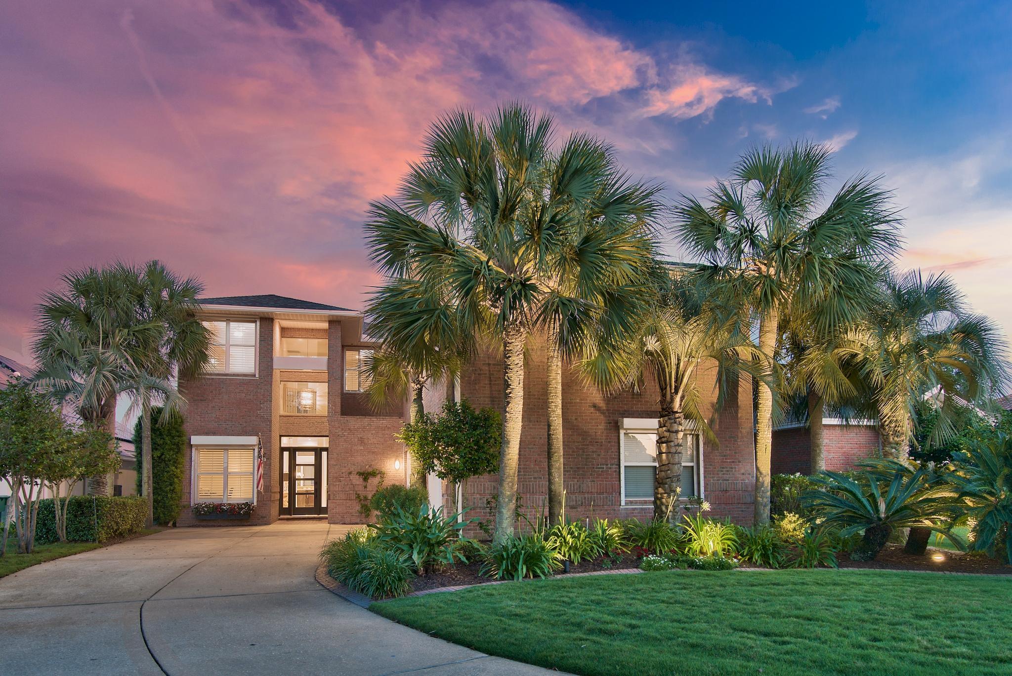 Offering the most spectacular and expansive Bay front views on The Emerald Coast, this incredible luxury home has just completed a literal top to bottom  renovation including a new roof, paint, dock, HVAC system, and water heaters just to name a few! The first level features soaring two-story tall ceilings with new sliding glass doors, new custom gas fireplace, custom draperies made from material from Italy, master suite with attractive built-in bookcases, huge walk-in closet, new flooring, and master bath with new glass bowl sinks, custom back-lit mirror and designer pendants, formal dining room, as well as an office. The second level features two guest room and a bonus room. Above the 3 car garage is a large and separate guest quarters offering it's own bedroom, bathroom, kitchen, and