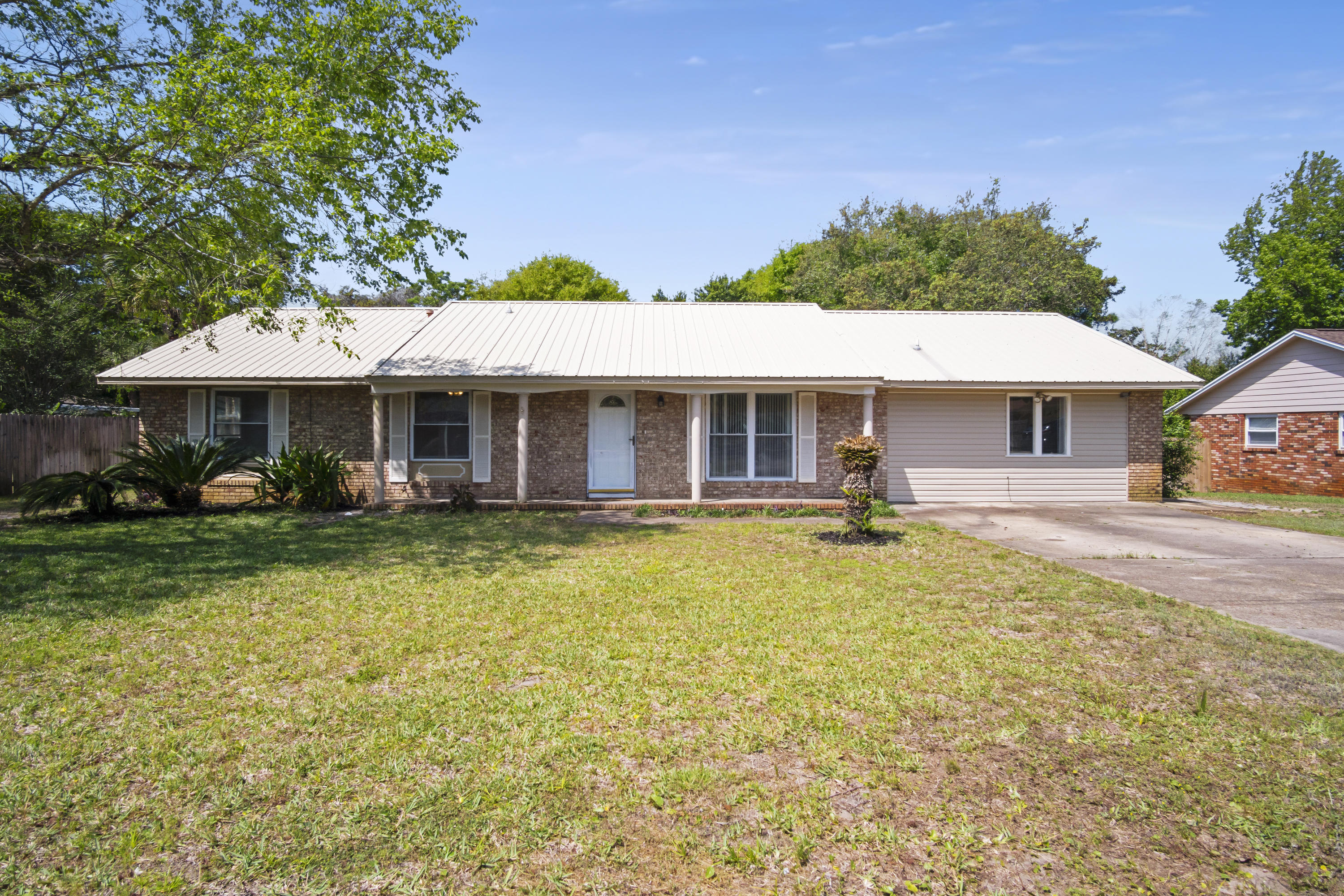 Space for everyone and their water toys!This big 4 bedroom, 2.5 bath is convenient to Joe's Bayou, the Harbor, and all that comes with West Destin living! Lot is a large 1/4 acre and with room and hookup for your RV. Inside you will find new laminate flooring, new flooring in the hall and main bath as well as the coolest kitchen in town! You will love the tin roof along with the newer cabinetry, appliances, and granite countertops. Ceiling fans throughout the entire home making keeping it cool a breeze! The shady backyard has continued the tin roof out providing a nice retreat. Firepit, sprinkler system, gorgeous and mature trees, storage shed with hot tub hookup, and fencing makes it such an easy space to love! Walkable to Destin Elem and proposed new HS