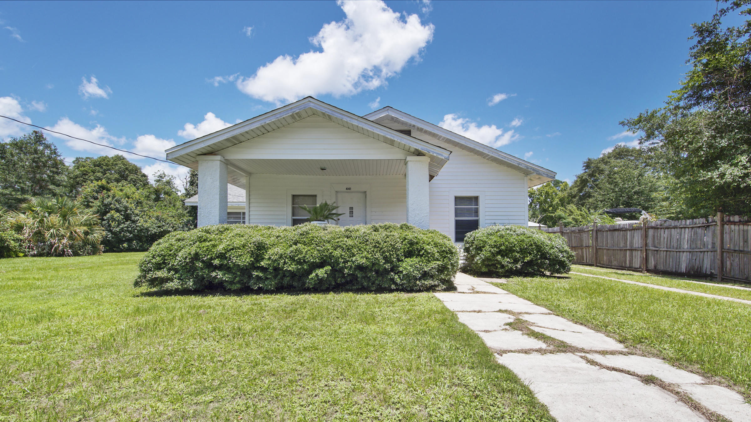 A true diamond in the rough, just blocks to Lake DeFuniak and across from the senior center. One of a few homes with many original features still intact. Oak floors need refinishing and are in the living & 3 bedrooms. Original doors & casing. Paneling & acoustic tile covering up what we believe are tongue & groove walls and ceilings in the original structure (kitchen & master were later add-ons). Check the room sizes - very generous, especially the kitchen. Roof & AC are from 2004. Water heater changed from gas to elec in 2016. Detached 2 car garage with openers and additional storage attached to garage. Lush, well established lawn and landscape. Room to add on if doing a larger renovation. Seller will not make repairs; selling ''As Is'' with price to reflect. So many possibilities here!