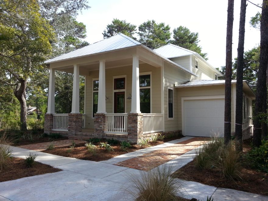 READY FOR OCCUPANCY. Florida cottage architecture at its best. Enter from the covered front porch into the open floor plan. The family and dining rooms feature a spectacular vaulted ceiling with a balcony overlook from the second floor. The gourmet kitchen boasts stainless steel appliances and quartz counter tops. The first floor master suite opens onto a screened porch that is also accessible from the laundry room. The master bath has an oversized shower, double vanity and a generous walk in closet. There are two bedrooms and a sitting area on the second floor. The home features classic Florida cottage trim detail. Forest Lakes offers a community pool with a pavilion and a stocked lake. A full facility public beach access is just minutes away.