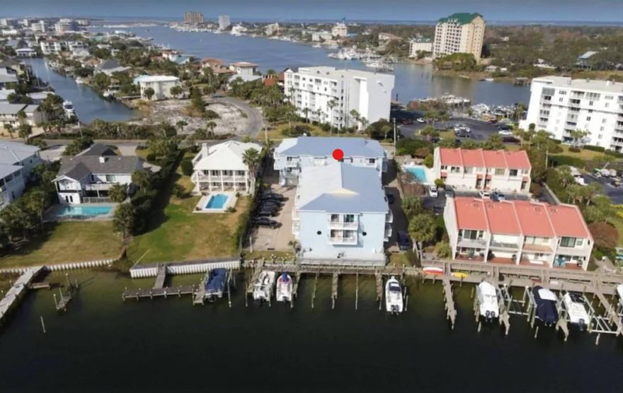 DETAILS : Harbor Front, water view - Holiday Isle! Owner occupied last 4 years; owner full time tenant 6 years prior to purchasing. Owner moving, discounted price due to pending purchase of new primary residence. No signs of mold or known leaks; energy efficient due to location; facing west. BENEFITS : customize interior exactly as you wish, new interior reduces future maint expenses / increases potential rental revenue. Large garage (rare, nice feature), golf carts allowed on Holiday Isle and across Hwy 98. Annual gross rental projection $45,000 - $55,000. FEATURES : harbor front, boat slips, small complex / 16 units, new metal roof in 2020, great location, sidewalks / landscaping, HOA protected, 5 min walk to gated beach access! Buyer responsible for all buyer and seller closing cost