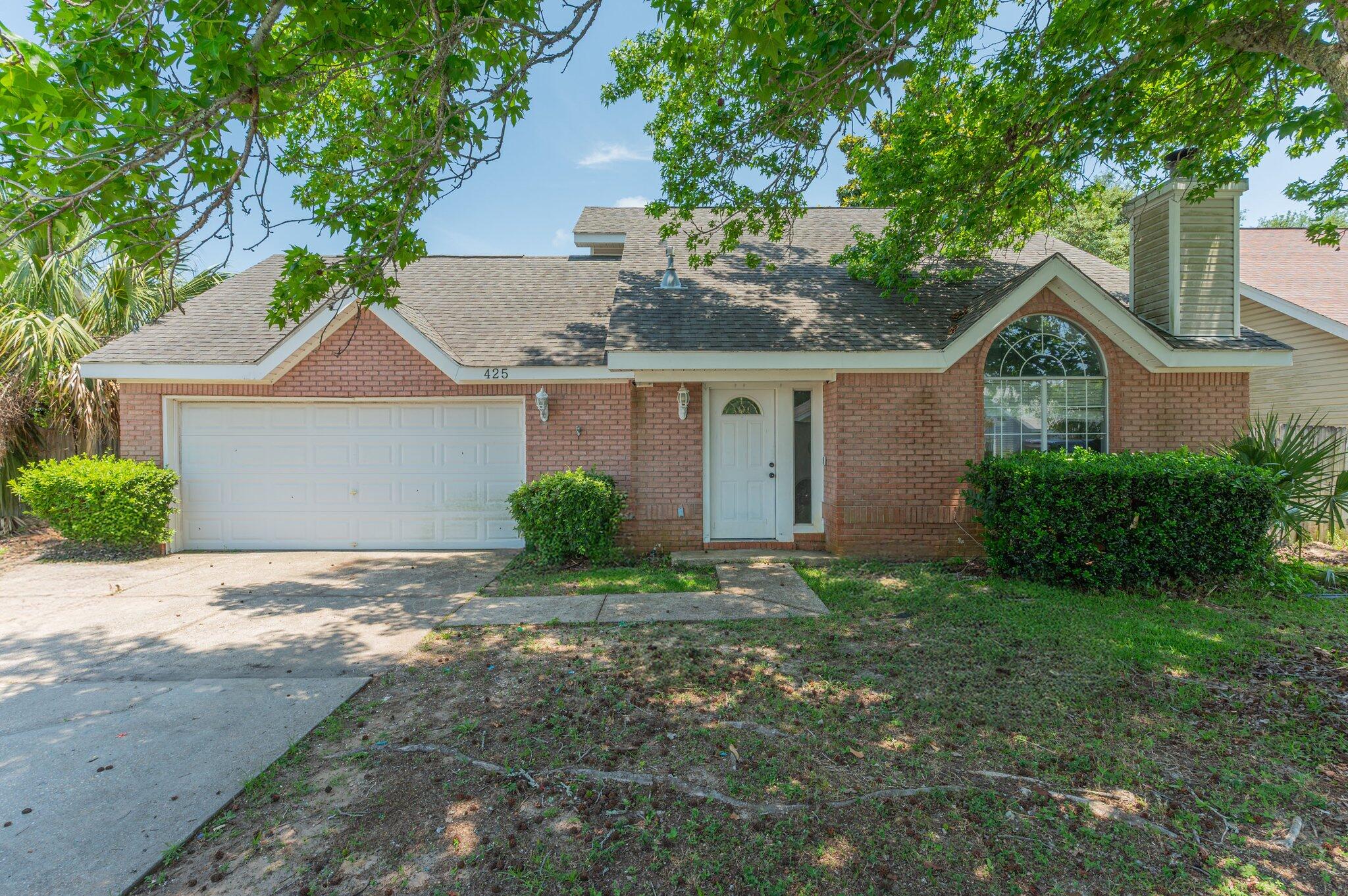 Welcome to 425 Bristol Cove Road, a charming and well-maintained home in the peaceful Bristol Park neighborhood of Mary Esther. This 3-bedroom, 2-bathroom residence offers just over 1,200 square feet of comfortable living space with a thoughtful split-bedroom layout that gives everyone a little extra privacy. The primary suite is conveniently located on the first floor, while two additional bedrooms and a full bath are tucked away upstairs. Inside, vaulted ceilings and plenty of natural light create an airy, welcoming feel. The kitchen includes a pantry and comes equipped with all the essentials, including an electric range, microwave, refrigerator, and dishwasher. Tile and carpet flooring throughout the home provide both durability and comfort. The living area flows seamlessly into the dining space, making entertaining easy.
Outside, you'll find a fully fenced backyard with room to garden, play, or just relax in the Florida sunshine. An attached two-car garage offers ample space for parking and storage. The home is situated on a manageable 0.10-acre lot, just minutes from shopping, restaurants, Hurlburt Field, and the sugar-white sands of the Emerald Coast.