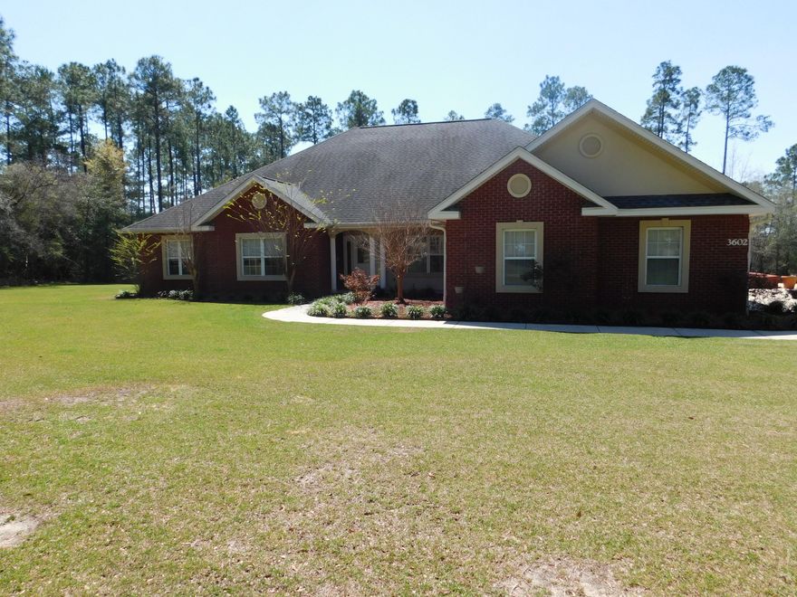Beautiful all brick custom built home on 2+ landscaped acres tree lined on 3 sides for privacy. This open floor plan features a cooks dream kitchen with gas stainless stove, stainless vent, silestone counter tops, large island breakfast bar open to family room with one of 3 fireplaces. Large living room opens to beautiful covered porch with with Hot Springs hot tub/spa and inground covered pool. Also included is upgraded wireless HD/3D projector with upgraded DVD blueray. Exterior upgrades include 12x24 warehouse/studio/office, 20x30 cement pad for rv/boat with covered 20x30 carport, sprinkler system, black aluminum fence with gate across front and additional storage building just to name a few. Upgrade list will be provided. 1 yr. home warranty provided.Don't let this one get away!!!