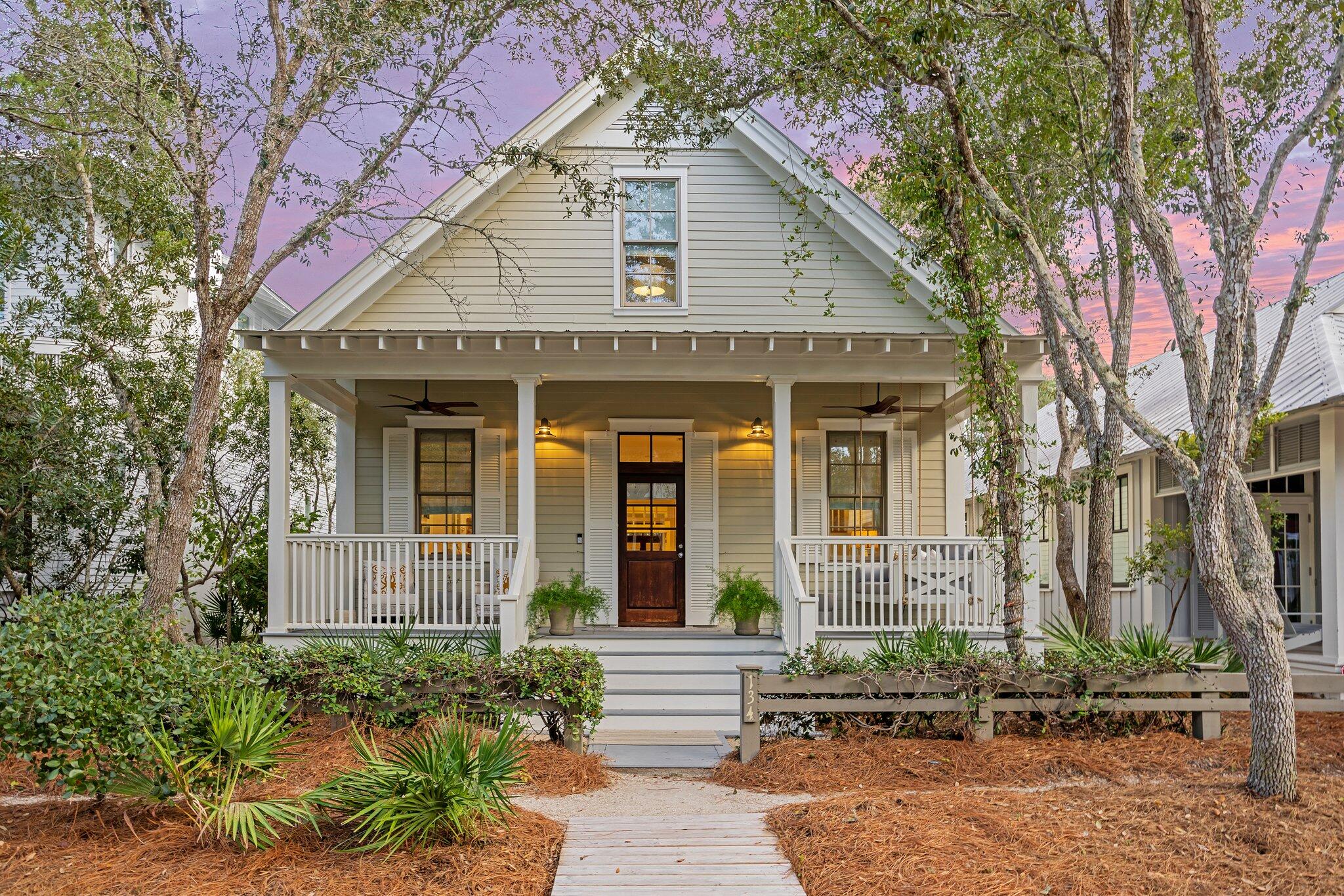 This pretty Florida Cottage oozes curb appeal, from the easy-to-maintain landscaping to the quintessential front and rear porches. Step through the wooden front door to find a bright, updated home that combines chic modernity with relaxed coastal charm. Hardwood plank flooring creates a natural flow from the sitting area to the dining space with its stylish new chandelier. New light fixtures and windows on either side deliver abundant natural light. The remodeled kitchen has white Shaker-style cabinets, open display shelving and new Caesarstone quartz countertops. It has a useful butcher block center island housing the microwave. Recent additions include a new dishwasher, sink with disposal and a range hood.  The generous breakfast bar provides a hub for social chatter and snacks. The rear hallway makes good use of space with a built-in office nook. Pass a half-bath and a laundry closet with stacked washer and dryer en route to the rear screened porch. Three bedrooms are complemented by additional space in the loft. It offers extra space for sleeping or being used as a cozy sitting nook for reading or for kids to play. The first-floor master suite has an updated bathroom with a twin vanity and oversized tiled shower. It has direct access to the rear porch with ample space for lounging and leisurely dining. Two additional ensuite bedrooms are tucked beneath the eaves on the second floor. The fenced rear yard has a paved patio for barbecues and stargazing while hanging out around the fire pit. There's a newly paved parking pad and enough exterior space for a pool or carriage house for those who want to expand. Offered fully furnished, this charming cottage has a renovated primary bathroom, remodeled upstairs bathrooms, interior paint in 2022 and new outdoor ceiling fans. Current rental projections of $165,000 could be significantly increased to more than $200,000 with the addition of a pool. Located in the highly desirable Park District of WaterColor's Phase I, this home is just steps from the beach club, fully stocked boathouse, Camp WaterColor and Seaside, Florida's, Central Square. It offers easy access to the best amenities along 30A, along with community pools, tennis courts, boardwalks and green spaces closer to home. 
