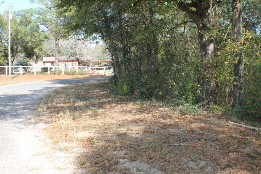 Homesite Dream! Huge hardwoods small creek and lots of Paved road frontage! This location is in the Auburn area near the new developing commercial of North Crestview! With highway 85 near by its just a quick commute to Crestview, Eglin and Destin Beaches! Bring you barn, RV and your house-plans today! Additional acreage available!!