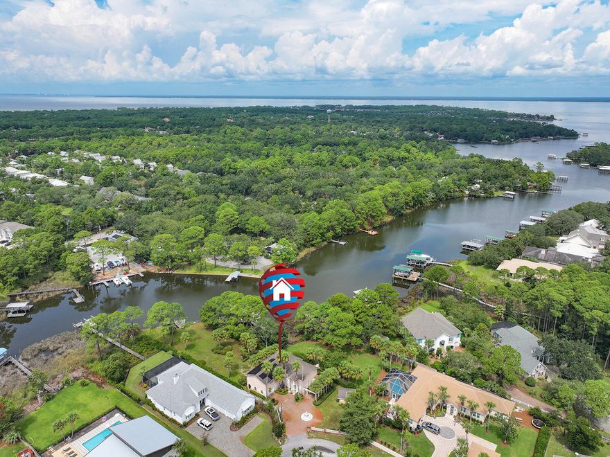 Amazing opportunity to own this spacious waterfront home on a huge lot on East Mack Bayou with over 93 feet of water frontage.  This waterway leads to the Choctawhatchee Bay, which can lead you to Destin Harbor, Crab Island, or the Gulf! Head to the white-sand sugar beaches of 30A or enjoy year-round fishing from your own backyard. This home is minutes from Sacred Heart Hospital and shopping, restaurants, and entertainment at Grand Boulevard. Bayou Pines has no active HOA, but the property comes with a 1/57th ownership interest and right to use the private boat launch for the neighborhood. This partially furnished home features 3 bedrooms, 3.5 baths, multiple living spaces, office, and huge wrap-around sunroom with water views. On the first floor there is a large sitting room with custom woodwork, fireplace, laundry room, living room with wet bar area, and a bedroom with an en suite bathroom. Upstairs there is a kitchen and dining area with amazing water views, large living area, and two spacious primary suites with water views! The first primary suite is located just off the upstairs living area and has a huge walk-in closet and an en suite with double vanity, whirlpool tub, and separate shower. There is also an office with water views and a half  bath near the living area.  The second primary suite is separate from the first for privacy and also has a large whirlpool bathtub with a separate shower.  Outdoors you will find a huge backyard with beautiful palmetto trees, plants, and flowers. There is plenty of room for a pool! Enjoy Florida living and amazing views on the covered patio. The exterior also has an oversized driveway that can fit 4-5 vehicles, a carport, and a shed. Schedule a showing today! Buyer to verify all pertinent information in listing, including dimensions.