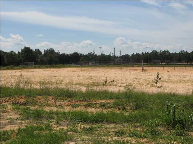 Clear level land that has a sand and clay base and was used for ballfields at one time. Located next to small city park and adjoins the Little League field. Fronts on 2 streets.
