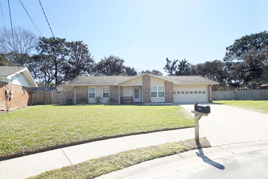 Immaculate home on a quiet cul-de-sac!  Screams ''I'm home'' from the minute you pull-up.   Enter through the bright foyer and enjoy views all the way to the back of the home.  Boasts 3 bedrooms, 2 bathrooms and  2 oversized living spaces and a screened in patio.  Tile runs throughout the living areas with new laminate flooring in the bedrooms.  The eat-in kitchen is at the front of the home with beautiful white cabinets and appliances.  The focal point of the living room is a stunning stone wall feature that reaches to the vaulted ceilings.  The two car garage has plenty of storage, to include, a hobby room.  The spacious fenced in backyard is ideal for a barbeque or harvesting from your very own lemon, grapefruit and tangerine trees.  Call now for your private showing!