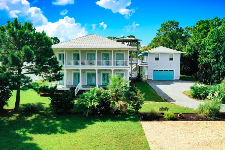 Great Bay Views! Beautiful Key West style plantation home across the street from Bay front park. Main house has 3,148 SF; 4 bedrooms, 3 baths, and master suite opening onto three story gazebo. All rooms open to large porches. Beautiful hardwood floors, tiled baths, built with the pro bolt system for hurricane proofing. Full house generator should that be needed.  Rinnai gas instant hot water in main house.   Beautiful pool in the backyard.  Privacy Fence.  NO HOA!  This is a great location for full time living or second home but, with no HOA, this would be a great property for an AirBNB or VRBO as well.  Bring your boat or jet skis, put into the bay right across the street. Oversized garage has great apartment above it with 577 sq. ft. with living room, kitchen, full bath, and bedroom.