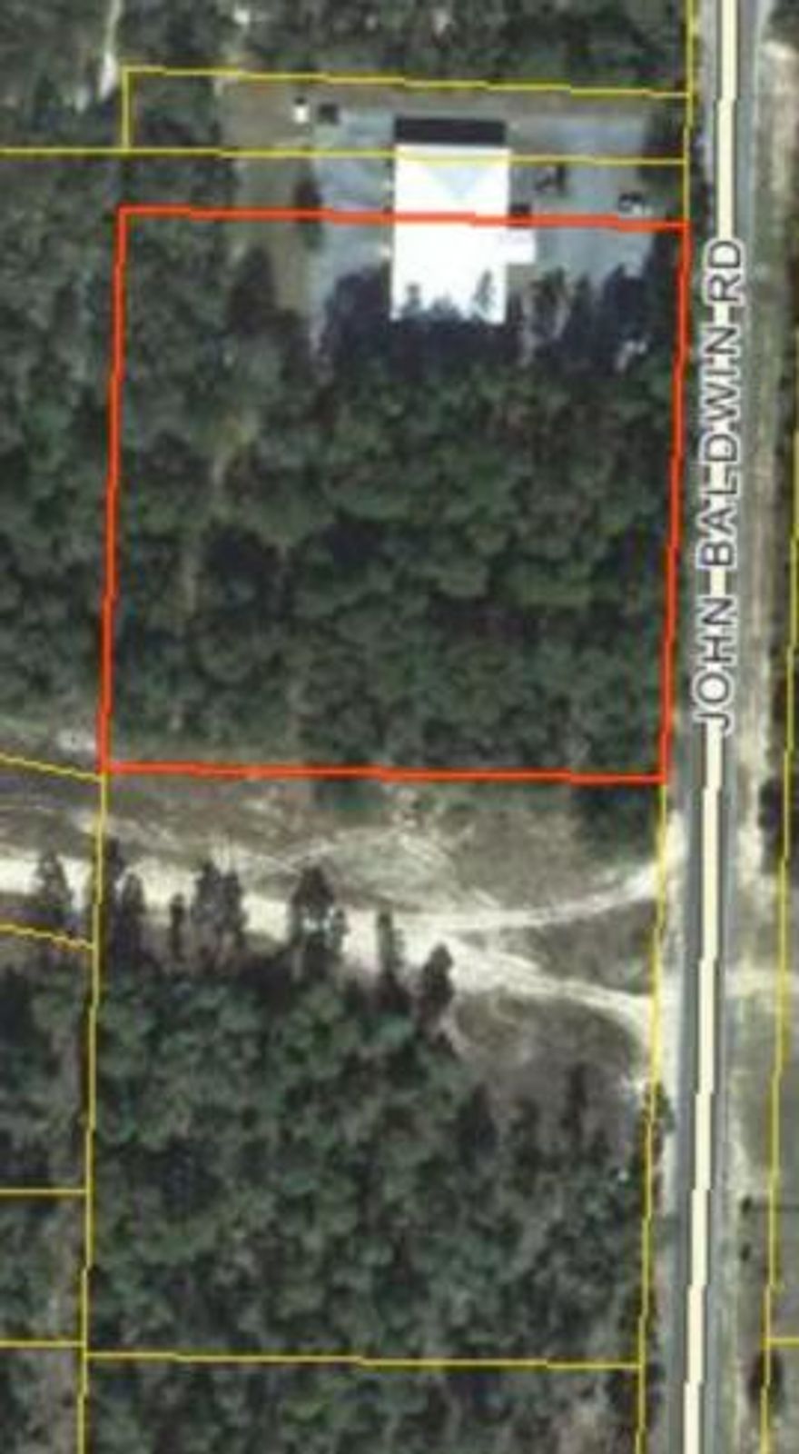 One high and dry wooded acre within the DeFuniak city limits, zoned R-2. Zoning allows single and multi-family residential as well as commercial uses: doctor or dentist office, pre-school or daycare, nursing home, or professional office. Situated just south of the USDA Service Center between Maude Saunders Elementary School and the WISE Educational Complex. 150 ft of street frontage. Can be combined with 2-acre parcel to the south, MLS # 734233. Owner Financing Available.