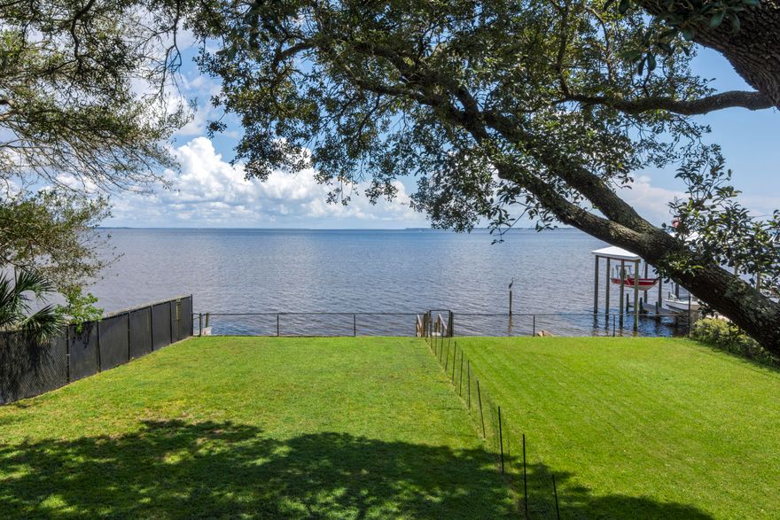 Hard to come by waterfront home in Elliot Point! Endless  water views over the Bay.  Upon entrance you are greeted by lush and tropical landscaping with an abundant amount of parking space for all your vehicles and guest. Two story home with 2500sqft of living space.  Two master suites! Master on second floor with lockout/private entrance if needed.