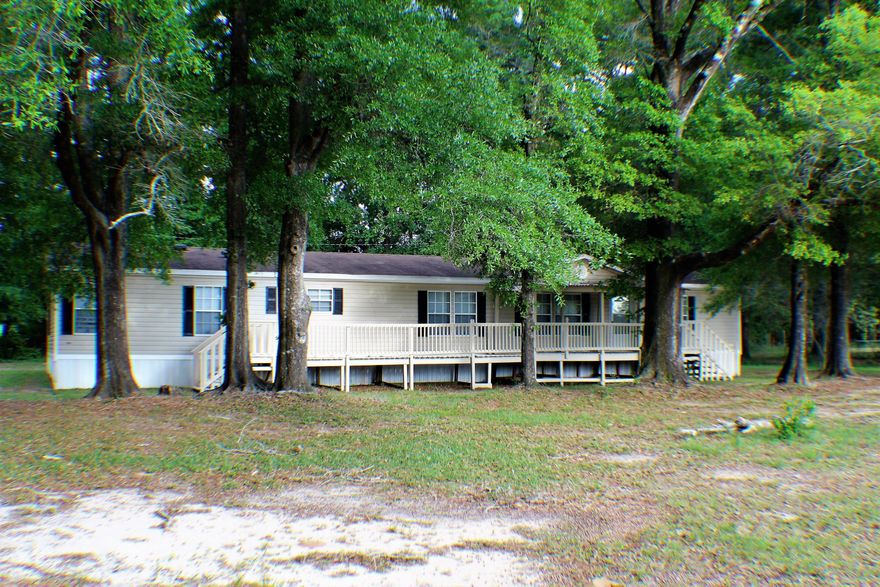 TRIPLE WIDE 4 bedroom 2 bath home. Recently updated with new carpet and fresh paint. Dream kitchen comes complete with pot filler faucet and huge island. 3 Living Spaces! Stone accent columns in the dining room as well as around the fireplace and master bathroom garden tub feature. Almost every room of this spacious home has a vaulted ceiling. Front and rear decks for easy outdoor living. Corner lot and private setting with a country feel. Close to Crestview and a short drive to Pensacola. ** Seller / Owner Financing Available **