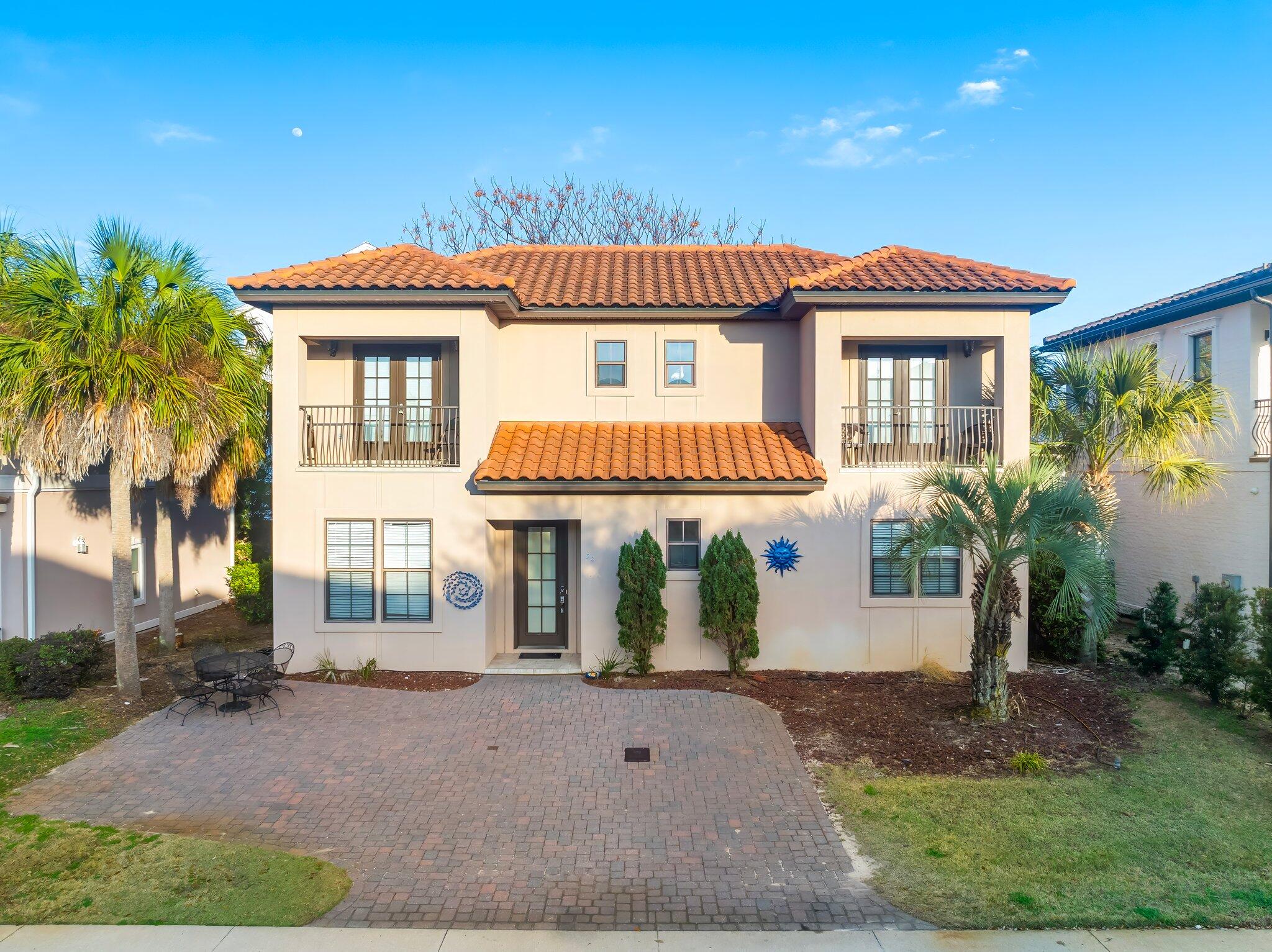 Just one block from the beach! This spacious 5-bedroom, 3-bath home is part of an exclusive gated community, and allows short term rentals! Located just a block from the beach, & the iconic, Pompano Joe's, this beach home offers the ideal blend of investment potential, vacation retreat, or a full-time/part-time residence. Just a short 5 minute stroll to the sugar-white sands and emerald waters, this property provides a great incredible opportunity to be on Scenic Highway 98. Step inside to find a spacious and thoughtful layout, featuring an open-living area with natural light and stylish coastal finishes. The well-appointed kitchen has granite countertops, ample bar seating and storage, making it ideal for entertaining, and those long stays at the beach! The three bedrooms upstairs all have their own ensuite full bathrooms, with two private balconies, and 2 additional bedrooms downstairs with a shared full bathroom. You won't be lacking space for all your guests! The home also features a wide paved driveway. There is also room in the backyard to build your own private patio with a hot-tub. After a day at the beach, enjoy all the nearby restaurants, shopping, and entertainment at your fingertips. All furniture & washer/dryer is included, and two new air conditioners were just installed. Whether you're looking for a high-performing vacation rental, or a dream beach home, this property has it all. Don't miss out on this opportunity to own just a block from the Gulf! Schedule your private tour today!