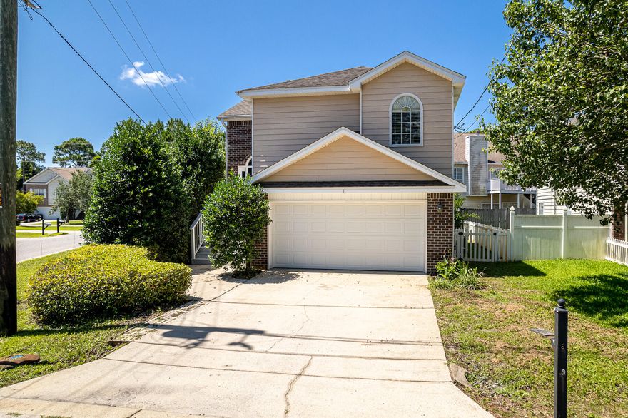 Welcome to 5 Lake Front Drive! This beautiful home is locate on a spacious corner lot in a neighborhood with NO HOA and is just a short distance to the bay. This home features an inverted floor plan with 3 bedrooms, 2.5 baths and a 2 car garage. 
On the upper level you will find the living room with a gas fire place, dining room and kitchen. The kitchen offers white cabinets with accent lighting and hard surface counter tops. 
The Primary bedroom is located on the upper level with a walk in closet and en-suite bathroom with dual vanity sinks, soaking tub and stand up shower. 
On the ground level you will find your 2 guest bedrooms, bathroom , laundry room and access to the two car garage. On the exterior of the home you can enjoy the sunsets from the upper outdoor patio. The back yard is fenced is fenced in and has several fruit trees throughout. 

This home is conveniently located between the beach and the bay in Miramar Beach. It is close to shopping, dining and a variety of entertainment.