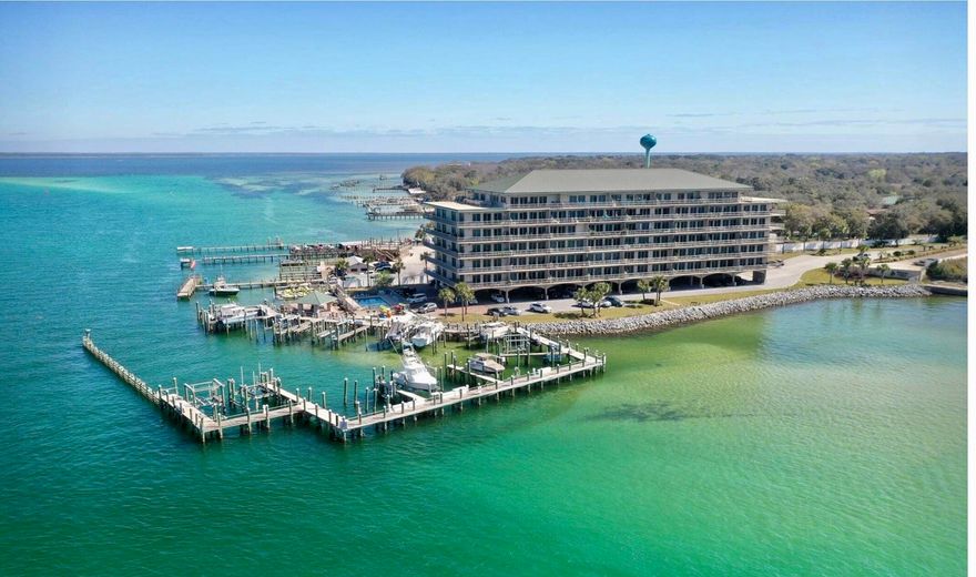 Experience coastal living at its finest in this beautifully updated waterfront condo complete with a 30' deeded boat slip and a 12k lb lift, offering panoramic views of the Destin Harbor, East Pass, Crab Island and Gulf waters! Watch boats cruise by, dolphins play, and enjoy breathtaking sunsets right from your private balcony! Spacious 3 Bedroom/3 Bathroom with 2,196 square feet of stunning living space to include 10ft ceilings and 8ft doors throughout! Expansive floor-to-ceiling windows bring in natural light and frame the stunning water views. The open layout connects seamlessly to the balcony, perfect for indoor-outdoor living. Beautiful modern kitchen equipped with stainless steel appliances, double ovens, wine cooler, tons of custom cabinetry, granite countertops, and pantry space. A perfect breakfast bar is attached and offers additional seating and entertaining space. A formal dining area is open to the living space and is the ideal spot to have family dinners as you enjoy the breathtaking water views!
Large primary suite is a true sanctuary that includes direct water views, and access to the balcony. The updated ensuite bath boasts dual vanities, soaking tub, walk-in shower, and elegant finishes. 2 additional bedrooms each with a waterview are generously sized for family and guests, both having private access to 2 additional full baths and tons of closet space. Sides Moreno Point West offers a host of resort-style amenities to include pool, marina, and gated entry. The secure building provides peace of mind, and the assigned parking space ensures easy access to your condo in paradise. It is a prime location just minutes from Destin's shopping, dining, fishing and world-class beaches. Whether you are seeking a serene full-time residence, a luxury vacation retreat, or a lucrative investment property for long term rentals, this waterfront beauty delivers it all! Don't miss your chance to own this piece of paradise on the Emerald Coast!