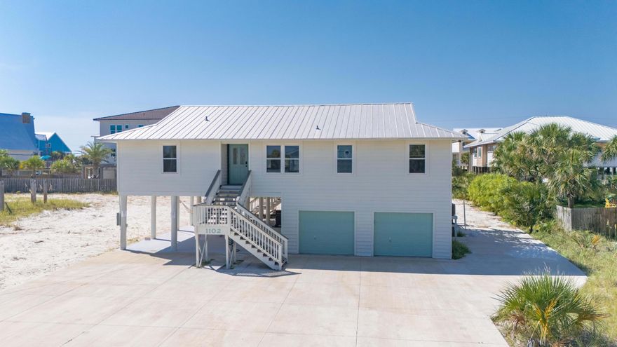 Step into this beautifully appointed 3-bedroom, 2-bath coastal haven--plus a flexible bonus area--nestled just one street back from the Gulf. The heart of the home features a well-designed kitchen with an island for casual dining, a chic high-end gas range, and an adjacent dining space perfect for shared meals and game nights.Sliding barn doors throughout lend rustic charm, while the living area invites relaxation with a generous sectional and comfortable seating. The primary suite offers both a king bed and crib, with an en suite bath and standalone shower. Two additional bedrooms also feature king-size beds, and the bonus zone includes a queen Murphy bed--ideal as a guest area, home office, or fitness nook.