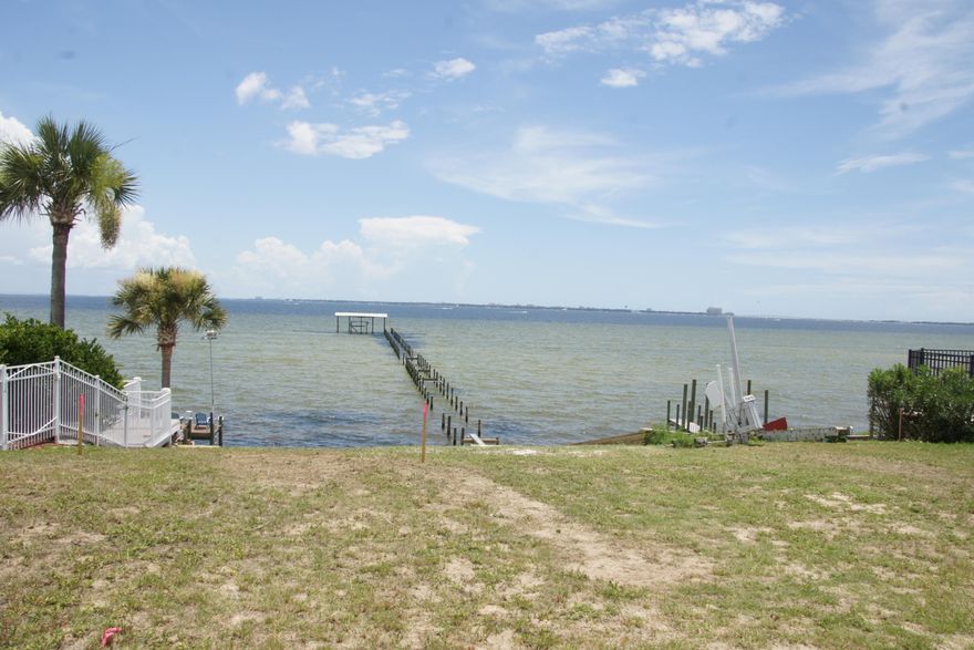 Sitting on top above Shalimar Pointe this lot offers unlimited view of  Destin, FWB, and of course Choctawhatchee Bay.  You will be watching the dolphins and fish play while relaxing on your deck.  You will enjoy all the new amenities added to the lot to include your own beach area.  Whether you have spent the day playing on the water or working on your new home the shower on the deck makes for easy clean up.  Lots of rocks has been added along the water edge of the property. A new survey was just completed.  The water tap has been paid.  The current dock goes out 40 feet with the potential to go out further.  Start living the dream today.