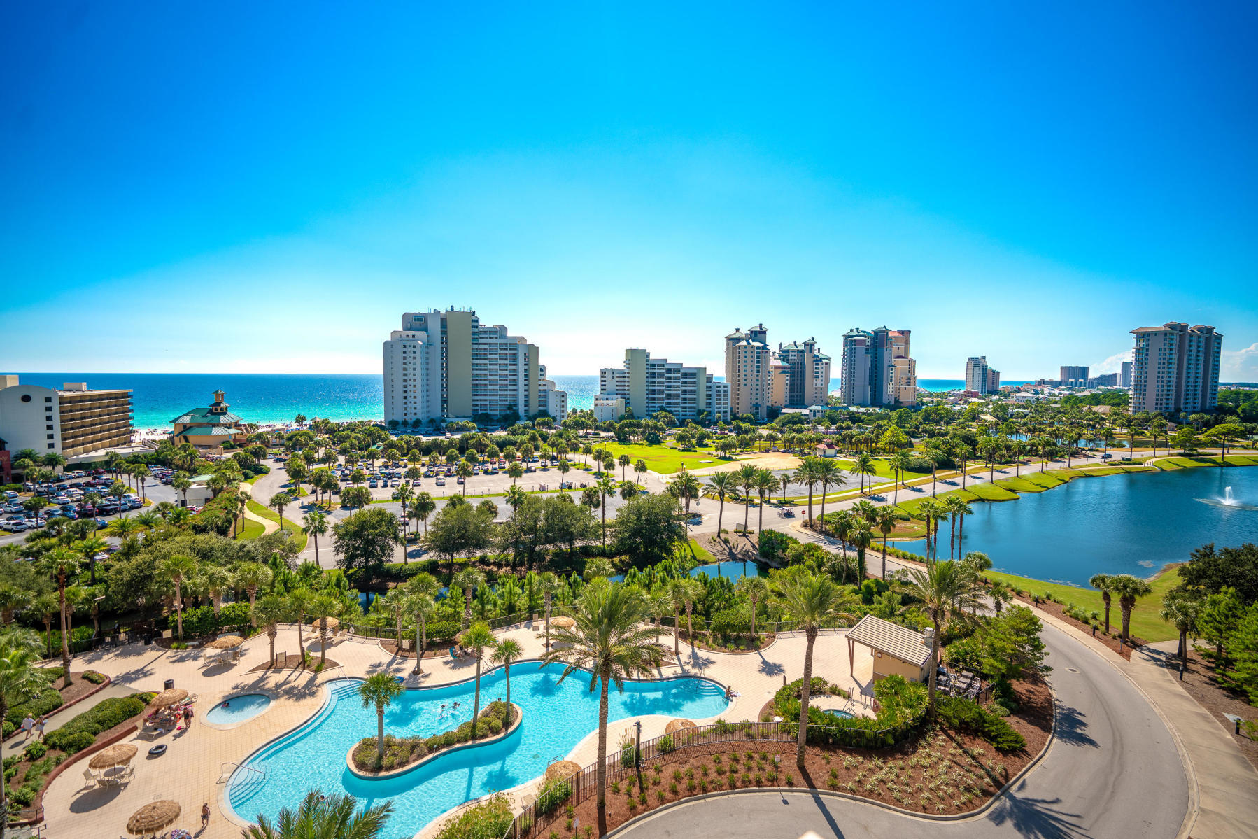 West-facing, 7th floor for the best Day and Evening resort views - Gulf, Lake and Bay. LUAU features gated, covered parking, a roof top observation area, large heated pool with a swim-under waterfall and a heated spa. The entry fountain, BBQ area and swimming pools are located along a stream that winds through the complex's lush landscaping. There is a fitness center in the complex, helping to make Luau a self-contained oasis.