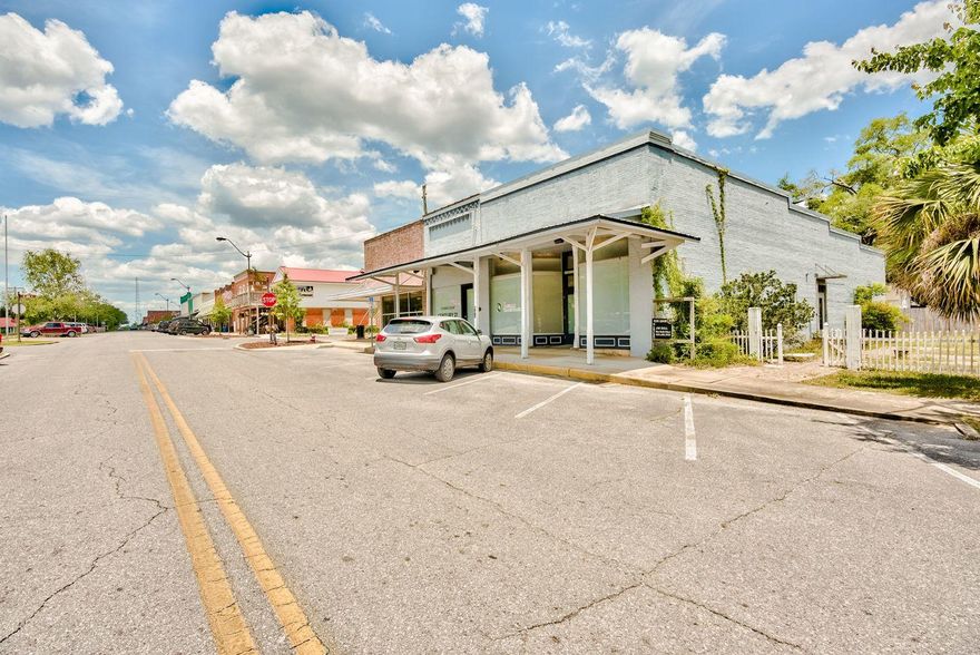 Landmark location on the iconic commercial street of Baldwin Avenue in historic DeFuniak Springs. This building erected in 1900 is a prime location for a tap room/wine bar venue to anchor the east end of this thriving commercial street overlooking the famed and unique lake DeFuniak, just one of two of the almost perfectly circular spring fed lakes in the world. With a historical Coca Cola mural and an expansive outside patio area, this building is the perfect spot for a themed food and beverage establishment. Also, the entire grounds to the east could be used for small concerts and food truck festivals. Total footprint is 3738sf with 3378sf heated and cooled inside and 1800sf outdoors.