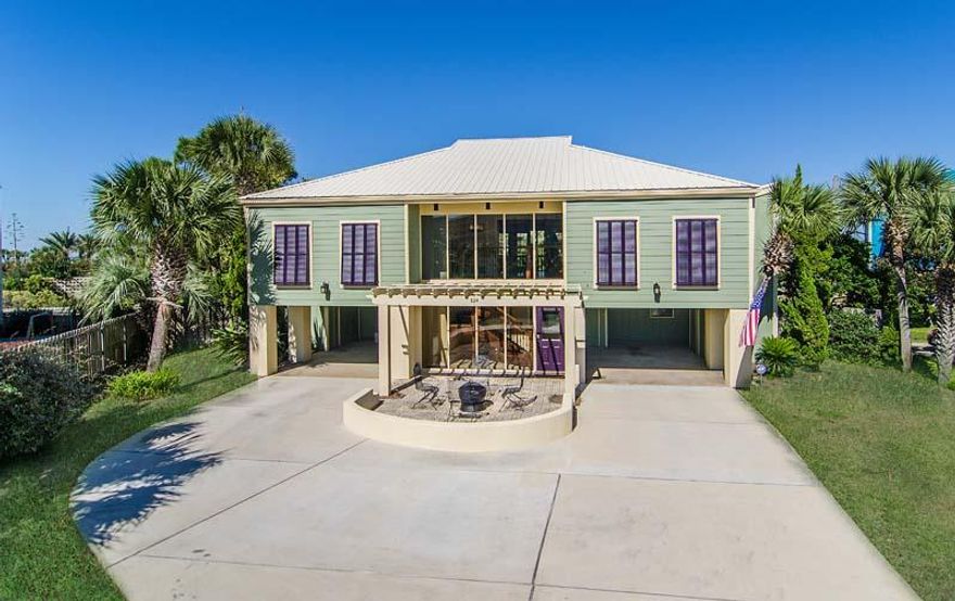 Enjoy Christmas in your new beach house this year! Swimsuits, shorts and flip-flops are a must when viewing this home since you'll want to experience a stroll along the miles of undeveloped beach unique to this section of Okaloosa Island. The emerald waters are approx 300 yards from your front door! The exclusive location of this fine property offers peaceful seclusion and unparalleled views of the sound creating a relaxed atmosphere you would expect to find in a luxury resort but with the added privilege of privacy and convenience found only through home ownership. Front entrance exterior amenities of this caribbean style home include tropical landscaping, bermuda shutters, a pergola covered entry way, fire pit and double covered car ports with plenty of outdoor storage