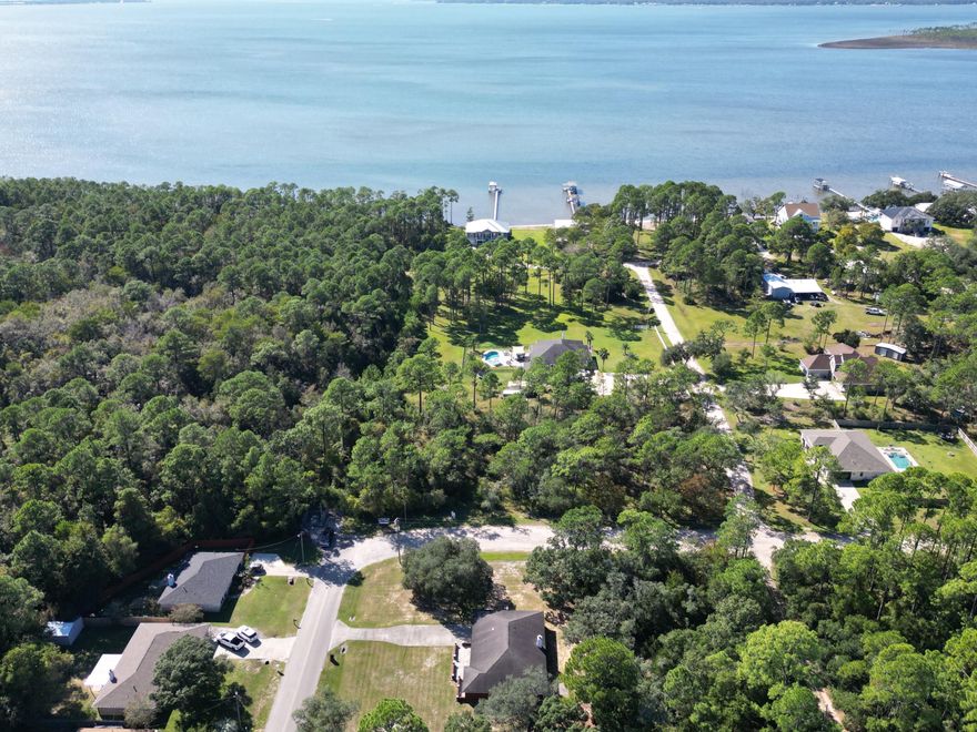 **.5396 acre parcel in a neighborhood that feels so private and serene and yet they have gatherings from time-to-time to provide a sense of community! The lot is just around the corner from Sorrento Rd., Big Lagoon State Park, and Perdido Key with its gorgeous Gulf beaches and connection to all parts of Pensacola. Access to NAS Pensacola is also fast and groceries, medical facilities, restaurants & more are conveniently close! . Zoned MDR Single-family dwellings (other than manufactured homes), detached and only one per lot, excluding accessory dwellings. Accessory dwellings only on lots one acre or larger. SEE DOCS FOR ZONING DOCS PER COUNTY and setbacks. ACCORDING to GIS map , no wetlands ( no study done), not in  flood zone (X), survey is available. The road is privately maintained wit  (see docs for the WTS-25-104738 file) NOTE: the aerial on property appraiser makes it appear there is an encroachment. There is not and has been cleared with a new current survey 