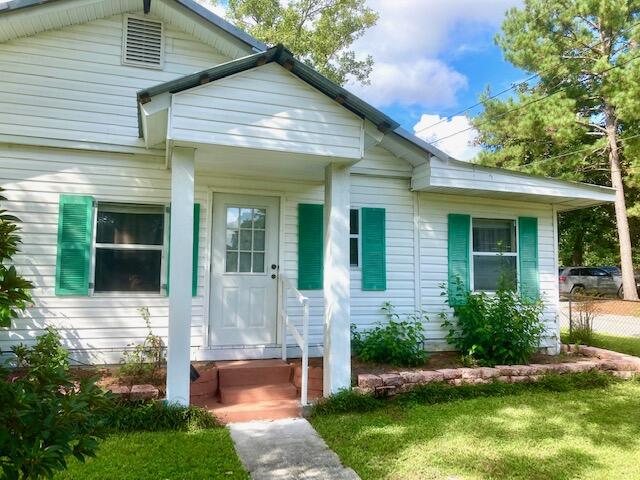 PRICE REDUCED!--NEED A CASH DEAL! This 3BR 1 BA home in town would make a good rental or home for a couple or small family. The house features a nice kitchen with breakfast bar, a dining room, LR, a den/office, and several porches. There is no central heat & air which makes obtaining insurance for a loan very difficult. HVAC could be added--there is attic space. The level lot features an extra ''tiny home'' building o the back yard that currently rents at $600 per month (renters would like to stay) plus an entry drive from the back alley for parking. There is also an RV hook-up. This house needs work (inspections show the wiring is inadequate and should be replaced). Property is being sold FURNISHED! Need a CASH offer for this home - no loans!