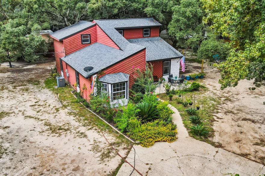 Sellers offering $10,000 credit to use towards buyers closing costs or rate buydown. Discover a hidden treasure nestled along Highway 87 in Navarre, where sustainability meets tranquility. Situated on a private 1.01-acre lot, zoned for agriculture, this property unveils a beautifully updated and remodeled home, cocooned by a flourishing garden of vegetables, fruits, and herbs. This turn-key ready home CAN BE sold fully furnished and has been thoughtfully updated throughout. It features 1,869 sq ft of living space, three generously sized bedrooms AND an oversized 20x11 bonus room that can serve as a 4th bedroom, office, den, or playroom. The kitchen has been updated with a spacious single-basin farmhouse sink, new countertops, freshly painted cabinets, metal farmhouse-style backsplash, and all new appliances. The expansive lot is a canvas of limitless possibilities and a haven for animal enthusiasts! Ducks, chickens, rabbits, pigs, donkeys, and goats, have called this place home. Impeccable attention to detail is evident, from well-maintained planter boxes to secure fencing, gates, and latches. The entire lot is fenced to provide the utmost tranquility. The detached workshop with a carport, was recently rewired with all-new electrical, making it ideal for tools, storage, outdoor gear, toys, or working on projects. Beyond its charm, this legendary property has earned recognition for hosting tours, field trips, and gatherings, making it a perfect spot for nature enthusiasts and animal lovers alike. Explore the vast landscape for hiking and fishing just steps away from the property. This Navarre gem offers a rare opportunity to live a sustainable, peaceful, and enriching lifestyle, all while being just a short drive away from shopping, military bases, and the pristine shores of Navarre Beach. Schedule a showing today!