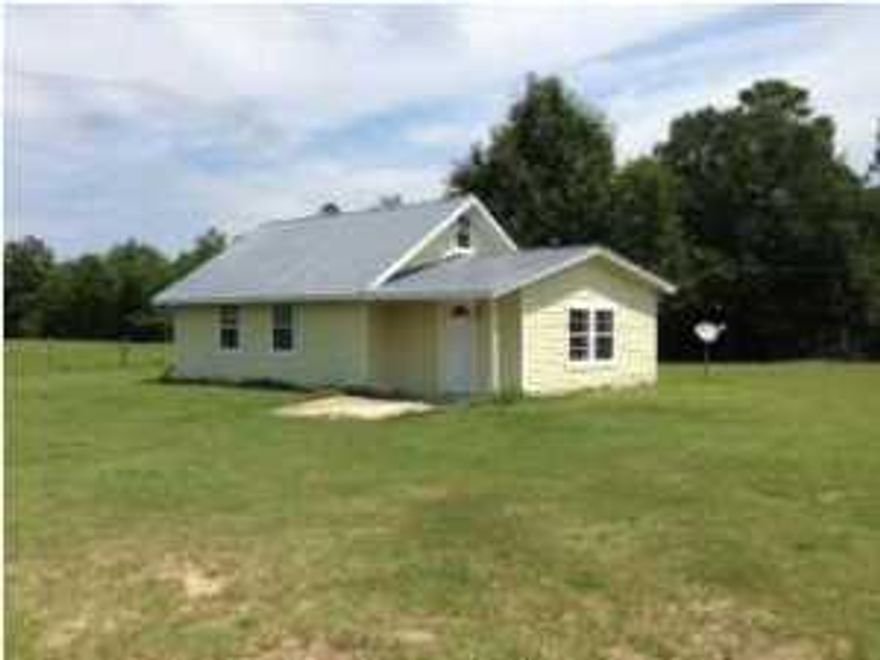 Lots of elbow room on this 3.11 Acre lot with 2 Bedroom two story house approximately 4 miles outside of Crestview. Lots of possibilities with this lot as well as with the house. Open floor plan when you walk in. Living area looks into large kitchen. Kitchen has been remodeled to include tile counter tops. Tile flooring throughout house. Kitchen has a pass through to living area which could be great for entertaining. Bathroom shower has also been tiled. There is a loft upstairs that could be an additional bedroom since the second bedroom downstairs is small. Large separate laundry room off bath. Buyer to verify all pertinent information. Property to be sold 'as is'.