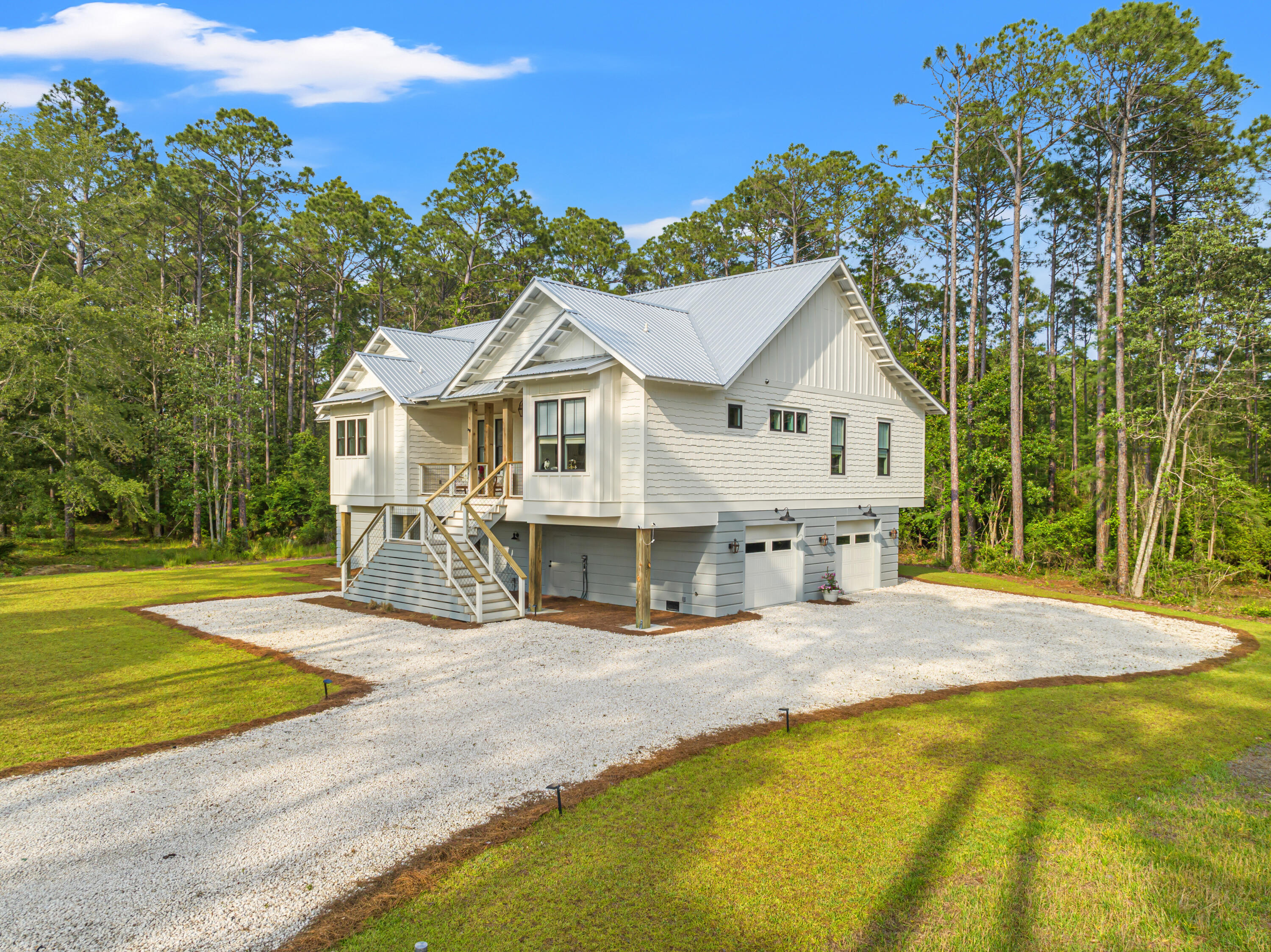 Welcome to this thoughtfully designed custom-built residence tucked within the exclusive, gated community of Rivercamps on Crooked Creek. Set on nearly an acre and surrounded by wooded preserve, this architectural gem offers an elevated blend of coastal charm and modern luxury across 3,750 square feet of living space, with an additional 1,150 square feet of screened outdoor retreats.At the heart of the home is a beautifully curated gourmet kitchen, featuring a 48'' Ilve gas range framed by a custom alcove with pot filler, authentic Moroccan Zellige tile backsplash, inset cabinetry, quartz countertops, a stunning white oak island, a walk-in butler's pantry, and a wet bar with beverage fridge-perfect for entertaining in style. The soaring cathedral ceiling with exposed beams flows into a cozy yet elegant living room anchored by a floor-to-ceiling stone electric fireplace and built-in bookshelves.
Step onto the upper-level screened porch and unwind in a wooded outdoor sanctuary complete with a gas fireplace, dining and lounge areas, and serene views--ideal for year-round enjoyment. The primary suite offers an attached home office with built-ins and wraparound desk, a spa-worthy ensuite with white oak dual vanities, makeup station, soaking tub, and an oversized walk-in dual-entry shower. A custom walk-in closet completes this tranquil escape.
Downstairs, the bonus room includes a dry bar with ice maker and beverage fridge, with ample space for a rec room, media lounge, or game-day gatherings. Just outside, the lower-level screened porch provides added privacy and features a hot tub surrounded by nature. A spacious laundry room was thoughtfully designed for everyday functionality, offering custom cabinetry, dedicated space for folding, sorting, and ironing, and easy access to the nearby drop zone/mudroom. Enjoy on-demand comfort with a high-efficiency Rinnai tankless water heater, providing endless hot water through out the home.
The gated, waterfront community of RiverCamps has less than 450 homesites on 500 acres with the remaining 1000 acres committed to conservation. RiverCamps is surrounded by West Bay, The IntraCoastal Waterway and Crooked Creek. There is a community boat ramp providing access to the Gulf and Shell Island with a short 30-minute boat ride. Owners also have access to community day-use boat slips and dry-boat storage. There are 7 miles of connected trails, the community is golf cart friendly and a new community pool is opening this summer. All conveniently located 10 miles from Pier Park, the famous white sandy beaches of Panama City Beach and 10 minutes from the NW Florida Beaches International Airport.