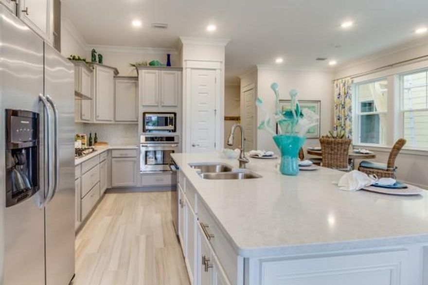 Completed in October! Upgrades include Acacia Ash Porcelain Wood look Tile floors on 1st floor, Carrera quartz countertops and ivory soft close cabinets throughout. The gourmet kitchen includes stainless steel appliances, Ice white glass subway backsplash and stainless farm sink. The master bathroom will be finished with Florentine Carrera 12x24 tile, dual vanity sinks, large walk-in closet, and a frameless glass shower door. Across from ''The Hub'' which features shops and multiple dining choices. Amphitheatre and Jumbo Tron light up the night with live music, movie nights, sporting and highly televised events. Standard features include 10 ft ceilings, tankless water heaters and natural gas cook tops.