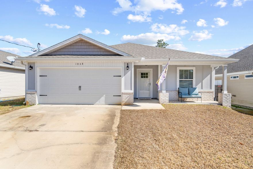 Built by Gulf Coast Cottages, this home has great curb appeal & design. Situated on a nearly quarter-acre lot, (50x200) this property offers tons of blank-slate potential in the front and back--just bring your green thumb. Built in 2021, you will find confidence in the age of the roof and all major systems. You'll enjoy the covered front porch as you enter the home. The spacious kitchen is ready for you to entertain, with granite countertops and breakfast bar. Stainless appliances, french door fridge, white cabinets with hardware, and stunning granite! Dining area is filled with natural light like the rest of the home. Beautiful Luxury Vinyl Plank floors in all the areas except carpet in bedrooms. Cottage style feel carried inside with cute panel doors. Primary suite has an en-suite bath The en-suite bathroom boasts a double vanity, shower/tub combo with new shower head, and generous walk-in closet. Nice sized 2 additional bedrooms and hall guest bath. Washer & dryer inside in laundry closet not in garage! Large backyard as lot is 200 feet deep. Seller added an extra 10k in fill dirt for proper draining too. Sprinkler system on well pump with a Rain Bird box. Plywood onsite for hurricane protection. Property on city water & sewer with a grinder pump onsite. Large entertaining/sun deck off the back covered porch. Ceiling fan and lights in covered back porch. Mosquito screen on back door and screen door on front door for those beach breezes to flow through. Washer & dryer included for buyer's convenience! No HOA! Long driveway for additional parking plus two car garage. Garage is 19x19 and has 2 new fans. Bar in garage and 4 bar stools remain if desired? Well maintained and move in ready!