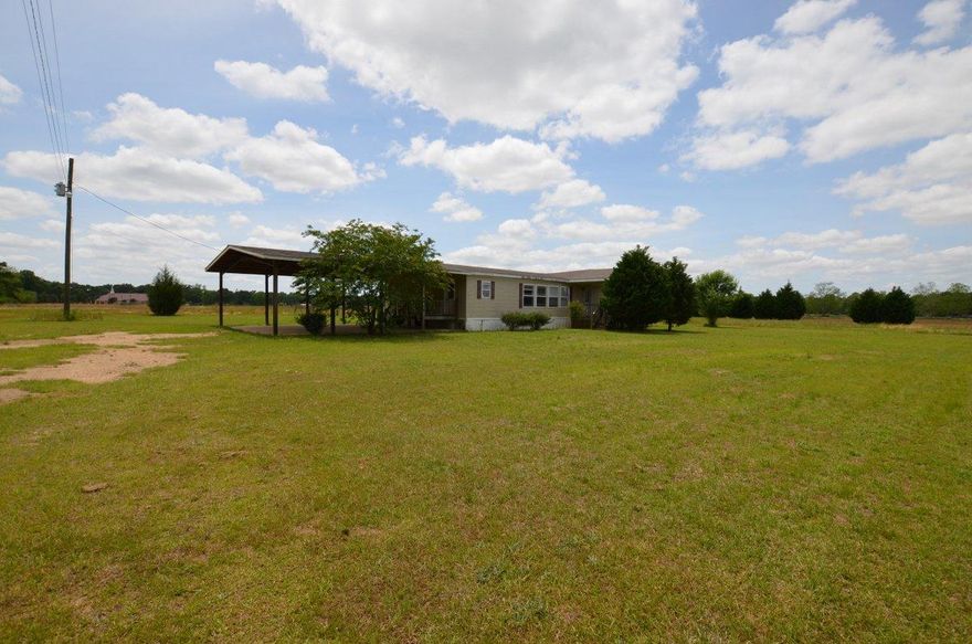 Country Living, Large Acreage, great price; this REO property has all the check boxes. This mobile home was built in 2005 and is 2280sf and rests on over 9 acres of flat pasture land. Home has split bedroom design with oversized master and master bath, 3 bedrooms overall and 2 living spaces (which was the 4th bedroom originally); one with a fireplace. Kitchen area is large and inviting with lots of cabinet space, kitchen island and oversized laundry just off kitchen. This home has lots to offer and is a must see to appreciate. Call today to set up your showing!
