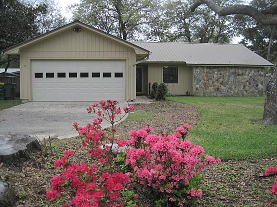 Beautiful move in ready, 3 bedroom, 2 bath home with a metal roof on a large shaded corner lot with a fenced backyard. This home has been meticulously cared for and it shows! Gorgeous plank style flooring throughout, NO carpet! Windows replaced in 2008, completely re-plumbed in 2014, wood fireplace with a blower and a brand new dishwasher March 2015. Custom door leads out to the large fenced backyard. Automatic sprinkler system in place to take care of your watering needs. The metal roof was put on in 2003. Leaf guard gutter system, Terminix termite bond in place. Convenient to Eglin AFB and the beaches with A+ Schools. What more could you ask for?