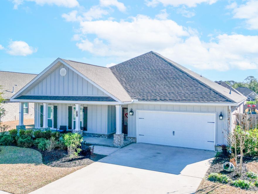 This stunning 4-bedroom, 2.5-bathroom home offers an open-concept floor plan designed for modern living. The spacious kitchen is a chef's dream, featuring granite countertops, a large island with extra seating, stainless steel appliances, and a gas stove—perfect for preparing delicious meals while staying connected to the oversized great room and dining area. The split floor plan ensures privacy for everyone! The primary suite is a true retreat, offering ample space, a walk-in closet with custom built-ins, and a luxurious en-suite bath featuring a garden tub and a beautifully tiled walk-in shower. On the opposite side of the home, three additional bedrooms with spacious closets share a full bathroom, while a half bath near the great room provides convenience for guests. Step into your enclosed patio, complete with portable AC/heating for year-round comfort. Get ready to host unforgettable BBQs in your new fully fenced in backyard, with paver patio spanning across the entire back of the home plenty of room for grilling, dining, and relaxation! Stylish gray-tone vinyl plank flooring flows seamlessly throughout the home, providing an elegant look with easy maintenance. Located in the highly sought-after Hammock Bay community, residents enjoy resort-style amenities, including multiple pools & lap pool, fitness center, Tennis pickle ball & basketball courts, Private movie theater, Dog parks, Walking & biking trails, Access to the bay, General store & more! Centrally located, just 30 minutes to the beach and 45 minutes to Eglin Air Force Base! Don't miss this incredible opportunity, schedule your private showing today!