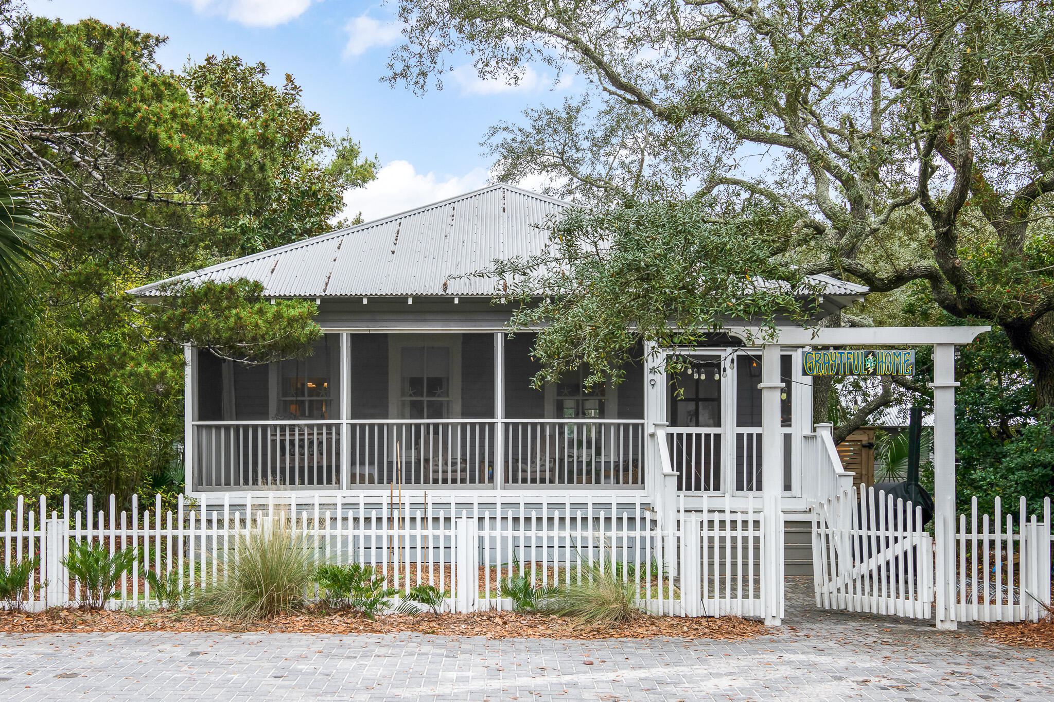 With an unrivaled location in the heart of historic Grayton Beach, this 3 bedroom, 3 full bathroom updated beach bungalow is just one block from the beach. Situated on a highly coveted extra-large lot and framed by century-old live oak trees, this home is a private oasis in the heart of town. Walk out your front door and the best of Grayton is steps away - dining, shopping, entertainment, the always-calm Western Lake, and beautiful Grayton Beach, twice voted the best beach in the United States. If people-watching is your thing, then you'll love the front porch at 149 Garfield. The screened porch is perfect for intimate gatherings, connecting with your neighbors, enjoying your favorite book, or just downtime. Kick back in the swing, enjoy a glass of lemonade, coffee, or your favorite beverage and take a step back in time.

For more intimate gatherings, head to the oversized backyard with its saltwater pool and lush vegetation. This is a perfect spot for family gatherings, pool parties, and barbeques. The backyard also houses a storage shed and is protected by a large privacy fence with a gate, allowing parking for several vehicles and room for a boat or RV. The size of the lot also allows ample room to expand the house or add a garage apartment. (Plans have been drawn by Matt Savoie of Savoie Architects).

Houses in Grayton Beach are a rare commodity. This home provides a laid back life-style in a perfect location. It won't last.