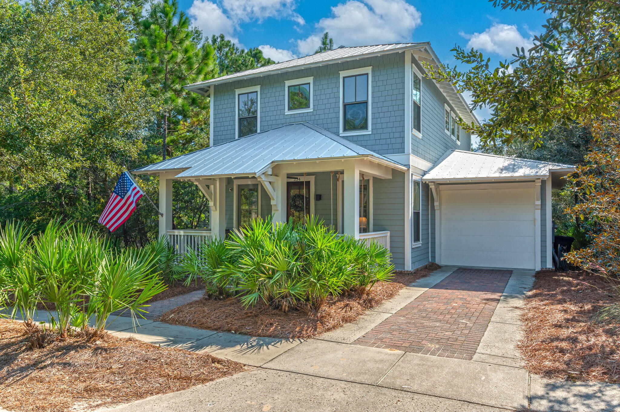 Welcome to Forest Lakes. Beautiful lake front Florida style cottage in the heart of Blue Mountain Beach. This fully furnished home features an open floor plan with a first floor primary bedroom. Hardwood floors, oversized molding, gas fireplace, quartz countertops, shaker cabinets. Stainless steel appliances including gas stove. Large lakefront first floor screen porch and large lakefront 2nd floor covered balcony. The screen porch leads out to the backyard facing the lake, with it fenced in. Beautifully landscaped with brick paver patio. Attached garage, with lots of storage. This gated community features nearby beach & state park access, playground, a lake with pedestrian bridge & a large Olympic community pool. Stocked fishing pond for catch & release. HVAC unit 2022.