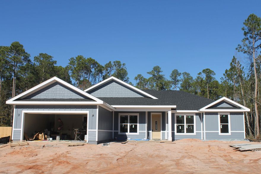 Nearing completion, estimated late January or early February. New Custom Home on .7 acres just north of town!! Another must see - Tons of little touches that are sure to catch your eye, such as  - stained wood accents, forever tile shower, six foot garden tub, upgraded lighting, Lifeproof flooring...and more. Structural upgrades include concrete siding, concrete soffits and covered back porch Extensive one year Builder's Warranty. Centrally located just 12-15 minutes from the beach or interstate 10.