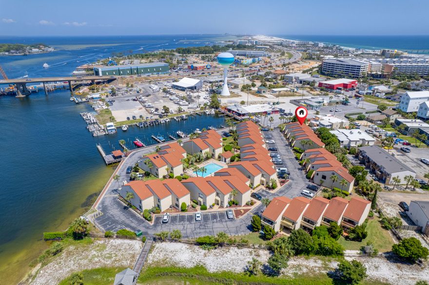 Boat slips, pool, and water views. Experience the beauty of waterfront living at Clipper Cove community on Okaloosa Island. Enjoy stunning water views and the convenience of private boat slips available for rent to owners. The prime location of this townhome community allows for easy access to the sound for fishing or the bayous and the popular Crab Island. Crab Island is a must-visit destination known for its crystal clear waters and vibrant atmosphere, perfect for water activities like paddleboarding, kayaking, and snorkeling. With beach access to the Gulf within walking distance and local entertainment just outside the gates, Clipper Cove offers the perfect blend of relaxation and excitement for residents. Freshly painted with all new fixtures, ceiling fans and LED lighting makes this property turn key! The spacious living and dining area features vinyl plank flooring, abundant natural light, and high ceilings. The kitchen has quartz countertops and updated stainless steel 'smart' appliances (& a 'smart' thermostat!) plus a breakfast bar. A large slider window, new kitchen fixtures and recessed lighting all with LED bulbs brightens up this spacious kitchen.  The main floor also includes an updated half bathroom and laundry room with ample storage


Downstairs, you'll find two master suites, each with upgraded bathrooms-one with a tub/shower combo and the other with a tiled shower. Both bedrooms have two closets. One of the bedrooms even has a private patio with extra exterior storage space. Just 200 feet from the Gulf, water access is easy at this waterfront townhome community on Okaloosa Island. Enjoy the covered gazebo for fishing and relaxing after a long day, as well as the large community pool. Short-term rentals are not allowed.