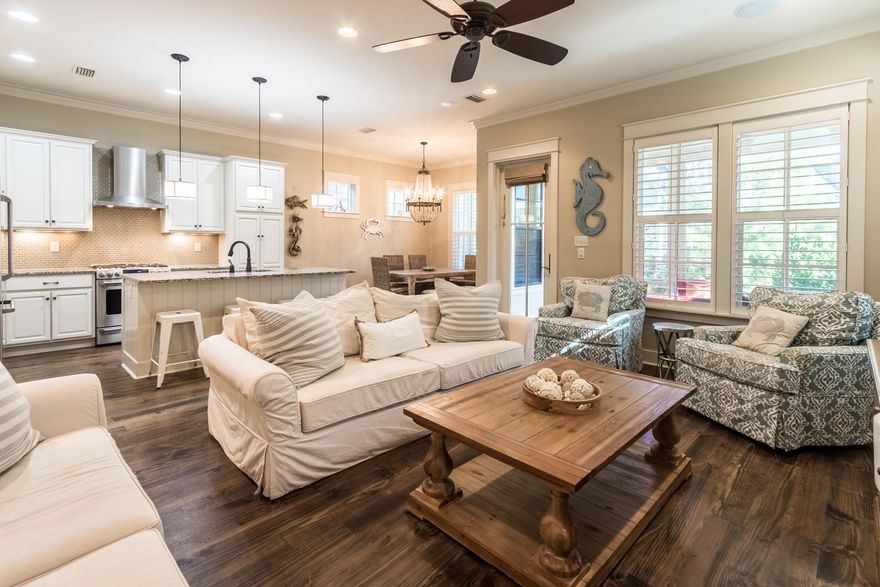 Ideal as a primary home or vacation rental in sought-after WaterSound Beach. This luxury residence is offered turn-key including all furniture, accessories, bedding and electronics. The home has been outfitted with many handicap accessible features, including a handicap accessible ramp. This three bedroom plus bunks and three and a half bath home offers hardwood floors throughout, v-groove wood walls, open concept living area with bar area and opens onto a welcoming screened in porch. Large windows introduce ample natural light into the living room which opens into the spacious white chef's kitchen including a granite topped island, stainless steel appliances and a wet bar with a wine fridge. The first floor is complete with one of two master suites with a spacious