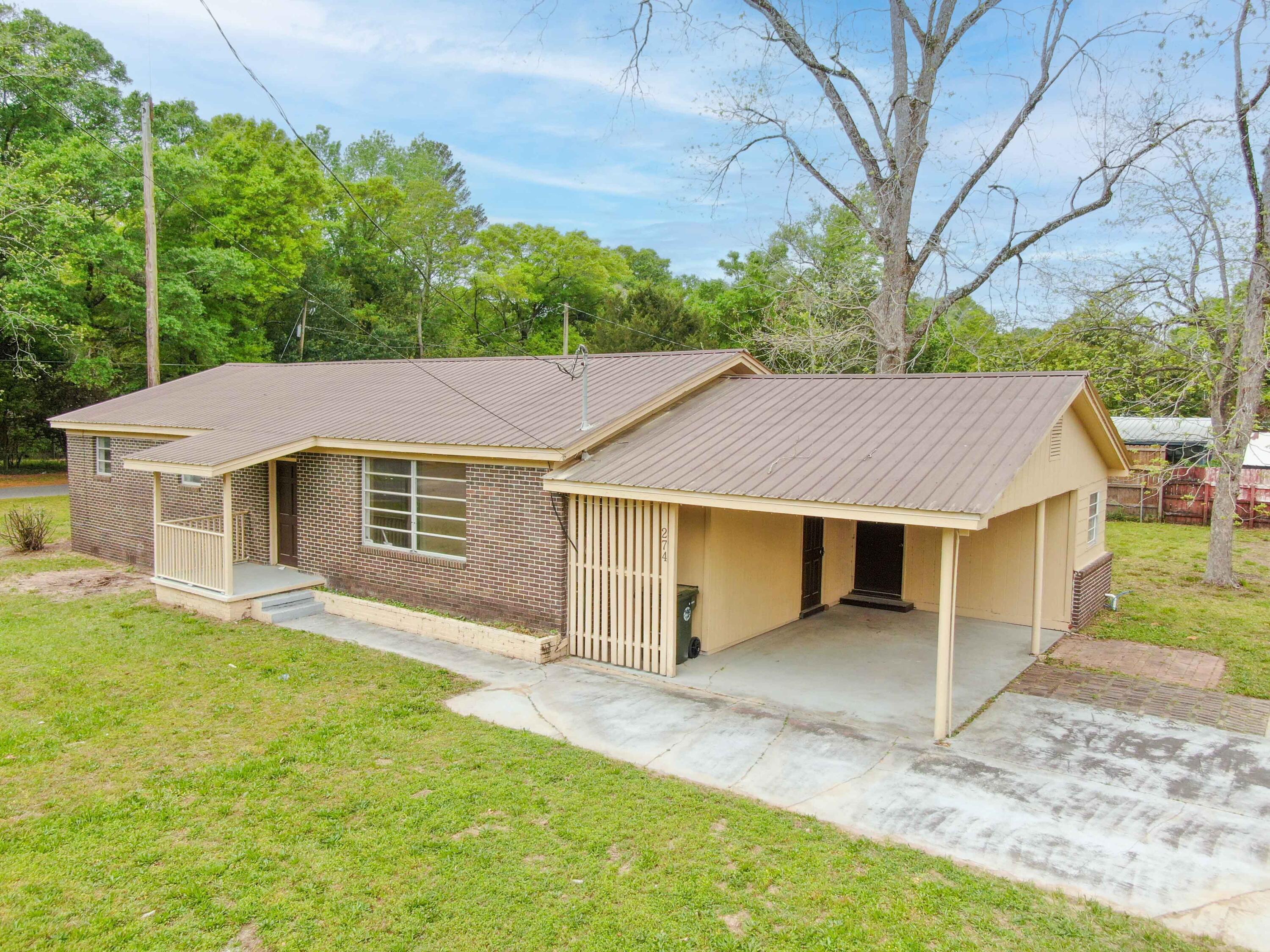 Investors and cash buyers, this is a must see. Almost 1750SF brick home with metal roof, 3 beds/2 baths and is a blank and ready slate for your finishing touches. Items to complete are flooring, appliances, and finishing the second bath with vanity and commode. Optional items including wiring and windows. There is an additional lot with a workshop/barn that has potential to be split and used or sold separately, to be determined by survey. You won't find a better value so don't wait to make this cash-only home your own!