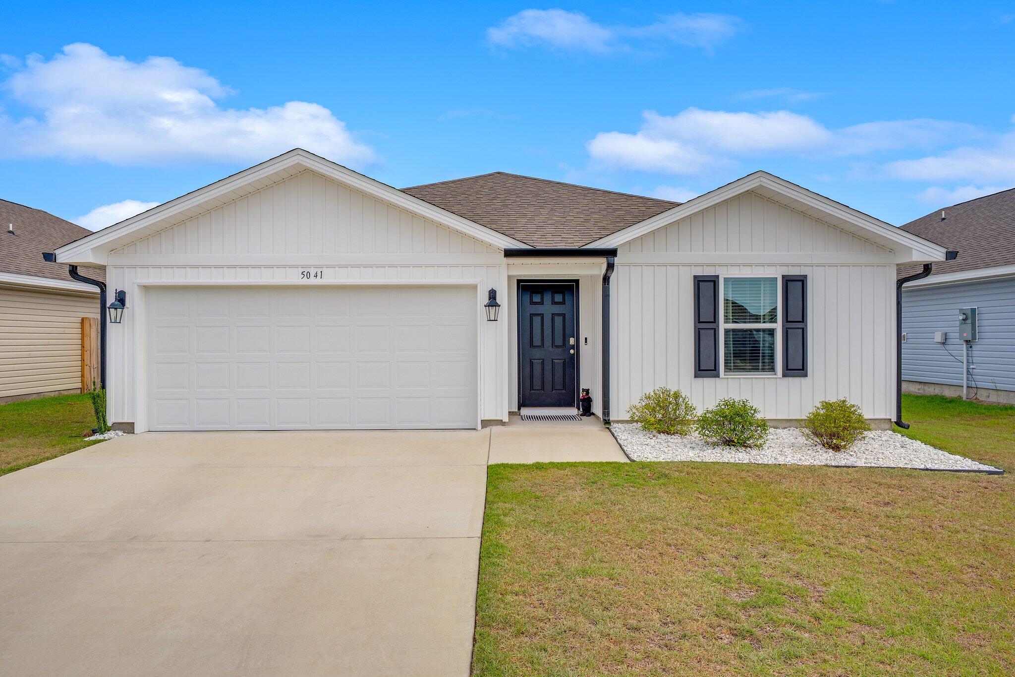 Welcome to 5041 Rivergrass Drive, a beautifully maintained 4-bedroom, 2-bathroom home located in the highly desirable Titus Park community!Built in 2023, this home offers modern features, thoughtful upgrades, and a prime location just one mile from Publix and other exciting new developments, including a future Starbucks, Circle K gas station, and McDonald's.Enjoy eye-catching curb appeal with newly installed black gutters that complement the crisp white and black exterior. A fully fenced backyard with white vinyl fencing adds privacy and style, perfect for outdoor enjoyment. Inside, the home features luxury vinyl plank flooring, recessed lighting, and upgraded lighting fixtures with stylish matching ceiling fans in each bedroom and the main living area. The open-concept kitchen seamlessly connects to the dining and living areas, ideal for entertaining. The spacious primary suite includes a generous walk-in closet and an ensuite bath.

Additional highlights include Smart Home Technology with a Yale smart lock, Skybell doorbell, and IQ panel that can serve as a security system. The garage has been freshly painted and upgraded with epoxy flooring for a clean, polished look.

This home also offers the benefit of an assumable VA loan with a 5.99% interest rate, making it a smart financial move for eligible buyers. Located in Flood Zone X, no flood insurance is required and with affordable homeowners insurance, this property is a rare find.

A resort-style community pool is coming soon, making this an even more appealing place to call home. Don't miss your opportunity and schedule your private tour today!

