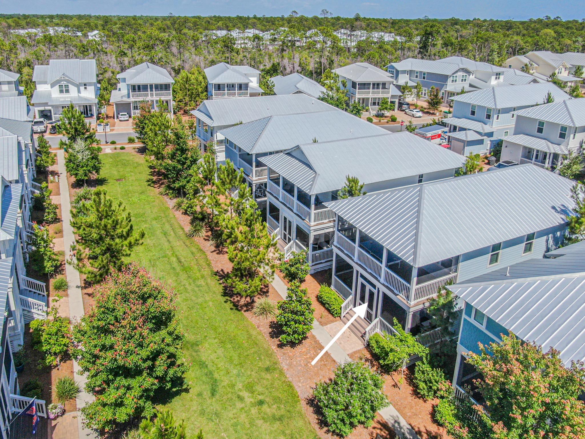 Welcome to Vitamin Sea! This beautiful coastal cottage is located on a special homesite facing a green space for little ones to run & play, or to play fetch with the family dog. Relax & take in the scenery on one of 3 porches- both front porches offer a front row seat to sunsets AND are screened!  And the front porch swing stays with the house. Rental projections close to $90k. This is the most sold plan in Naturewalk- so much to love! Wide open living, kitchen, dining makes entertaining and family time so easy. Kitchen features white shaker cabinets, upgraded marble countertops, white subway tile backsplash & gas cooktop with built in oven and microwave. The fun can flow out onto the 2 covered porches on first floor.