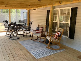 Welcome to Walton Plantation with all the amenities for outdoor and hunting fans! This gated community has miles of maintained dirt roads, thousands of recreational acres for hunting, hiking, ATV riding, fishing, gardening & a Campground Chapel with restrooms for owners to use and enjoy. This 1,263 sq ft manufactured home placed on 19 +/-acres, 416' on the water with 3 Bedrooms, 2 Full Baths, laundry room, spacious kitchen, living & dining room is a must see. Enormous screened in porch along with outdoor firepit, pole barn and Utility Building that is foam insulated. Gated entry to homesite as well. Additional acreage available for purchase next door.