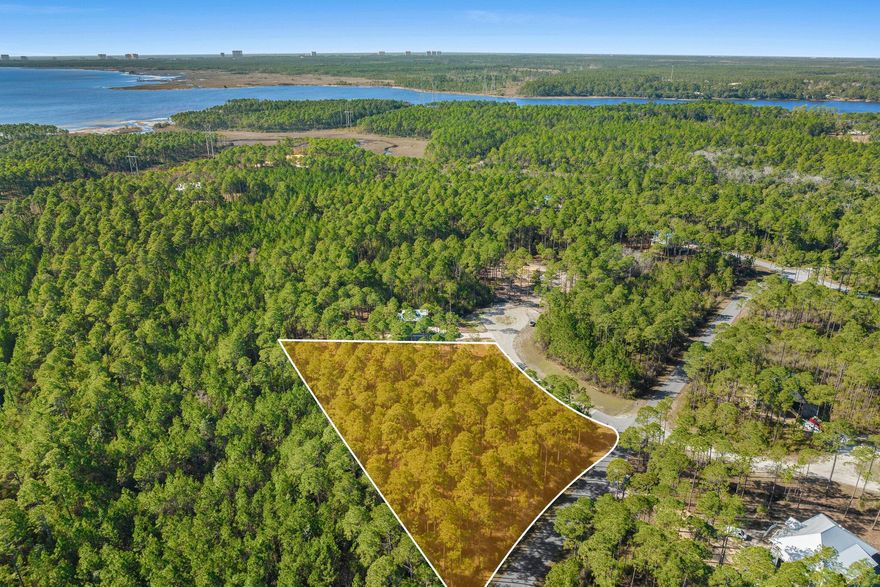 1.37-Acre Premium Homesite in RiverCamps - Build Your Dream Home! Discover the perfect canvas for your custom home on this expansive 1.37-acre corner lot in the exclusive RiverCamps at Crooked Creek community in Panama City Beach. Bring your vision to life or save time and money by taking advantage of already completed architectural plans from the Seller! This private residential community and wildlife sanctuary is truly one-of-a-kind and was designed with nature and water lovers in mind. Rivercamps is bordered by three sides of water with access to Crooked Creek, West Bay, and the Gulf. Over two thirds of the land is devoted to conservation. Residents enjoy the peace and quiet of 1,500 acres of woodlands preserve with less than 450 homesites. Enjoy unmatched amenities like unlimited use of kayaks and canoes for exploring, scenic nature trail system, fishing, campgrounds, community pool, and dry boat storage and day-slips. Conveniently located 10 minutes from the NW Florida International Beaches Airport and 10 miles from white sandy beaches. Amenity rebuild project is underway with pool completion expected soon.