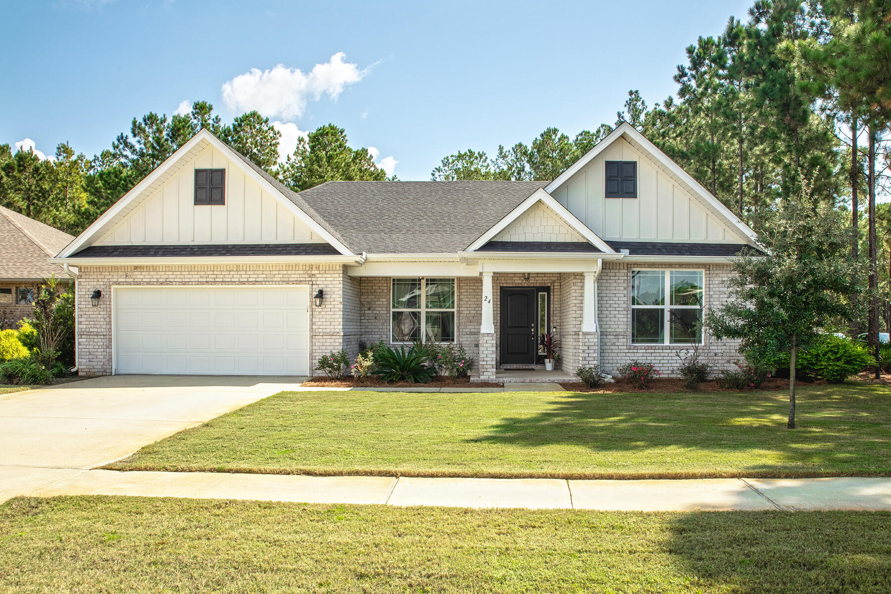 This home comes equipped with gorgeous upgrades including a built in storage bench and board and batten wall treatment in the front room. Your jaw will drop when you see the custom, oversized fireplace featuring a stunning thick wood mantle and an electric faux wood burning stove. The kitchen truly shines with its crisp white countertops that allow the island and backsplash to pop. It also features SS appliances, and a gas oven. The living area is one for the books with its volume ceiling and its massive window coverings, allowing the natural light to flood in. It flows in to the kitchen and sunroom dining area, making it a great space to entertain. The master bedroom invites you in with its beautifully selected brick accent wall, creating a cozy match with the dark accent wall.