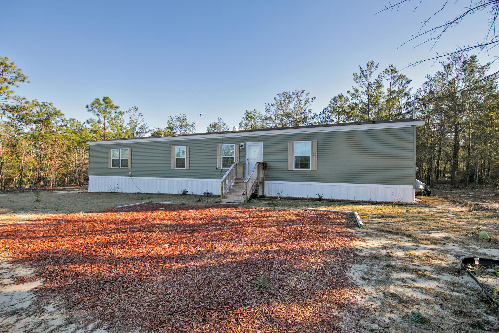 NEW Lowered Price. Close to the new industrial park off I-10, between DeFuniak Springs and Crestview a New 3 bedroom, 2 bath well-maintained mobile home on three lots on paved road. Plenty of room for expansion or add carport or shop. Make this your new home, immaculate shape and move in ready. Make an offer now. You won't find this size lot with new home at this price!