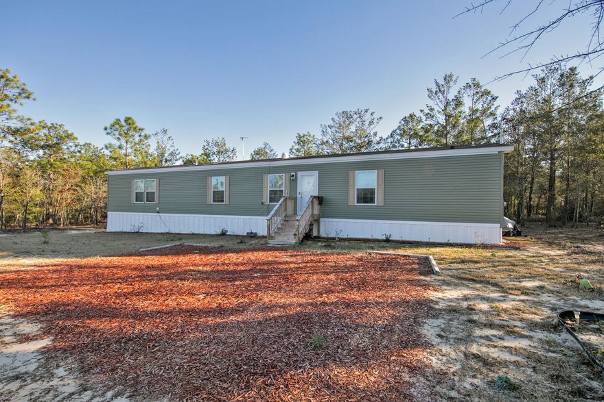 NEW Lowered Price. Close to the new industrial park off I-10, between DeFuniak Springs and Crestview a New 3 bedroom, 2 bath well-maintained mobile home on three lots on paved road. Plenty of room for expansion or add carport or shop. Make this your new home, immaculate shape and move in ready. Make an offer now. You won't find this size lot with new home at this price!