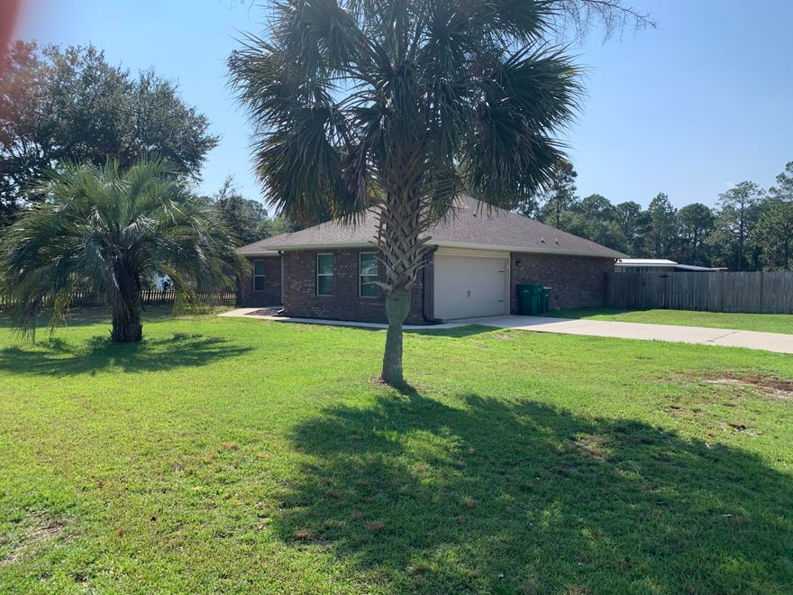 RARE...2016 ONE OWNER, 4 BEDROOM CUSTOM BUILT BRICK HOME FOR SALE IN NAVARRE.  TAKE ADVANTAGE OF THIS OPEN CONCEPT HOUSE THAT IS JUST OFF HWY 87.  CLOSE TO THE BEACH.
THE HOME HAS MANY UPGRADED FEATURES ON A OVERSIZE CORNER LOT. STARTING WITH A FENCED IN YARD, HIGH IMPACT WINDOWS, 10' TRAY CEILINGS , 2X6 WALLS, CUSTOM TILE
AND KITCHEN CABINETS.
PLUS, IT HAS AN ELECTRIC HEAT PUMP FOR HEATING AND AN OVERSIZED CENTRAL AIR SYSTEM WITH THE NEST THERMOSTAT.  12X24  BUILDING FOR ADDITIONAL STORAGE...DON'T MISS OUT ON THIS OPPURTUNITY