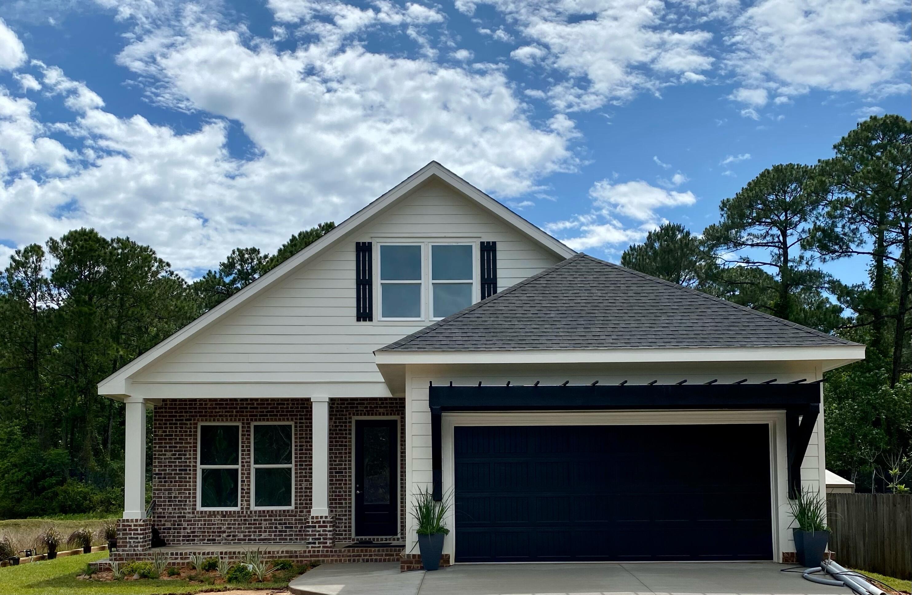 Price Reduced & $5k Seller Credits FOUND IT!! Come see this Beautiful Craftsman Style Custom Build that looks over Whisper Lake. Enjoy the quiet established neighborhood with beautiful tree coverage in Gulf Breeze, you will enjoy looking over the water while sitting on the back porch drinking coffee and watching the sun rise. This lot has plenty of room for a pool and sits on a large .73 acre lot. This spacious home has tall 10' ceilings & 8' doors w/ beautiful stained oak stair casing. Enjoy a massive Master Closet and walk in Pantry with Custom Wood Shelving throughout. This 2 Story Home is laid out with 4 bedrooms, 2 baths downstairs and an additional 1 bedroom 1 bath and a media room upstairs. This house has plenty of kitchen space for entertaining and cooking with friends and family.