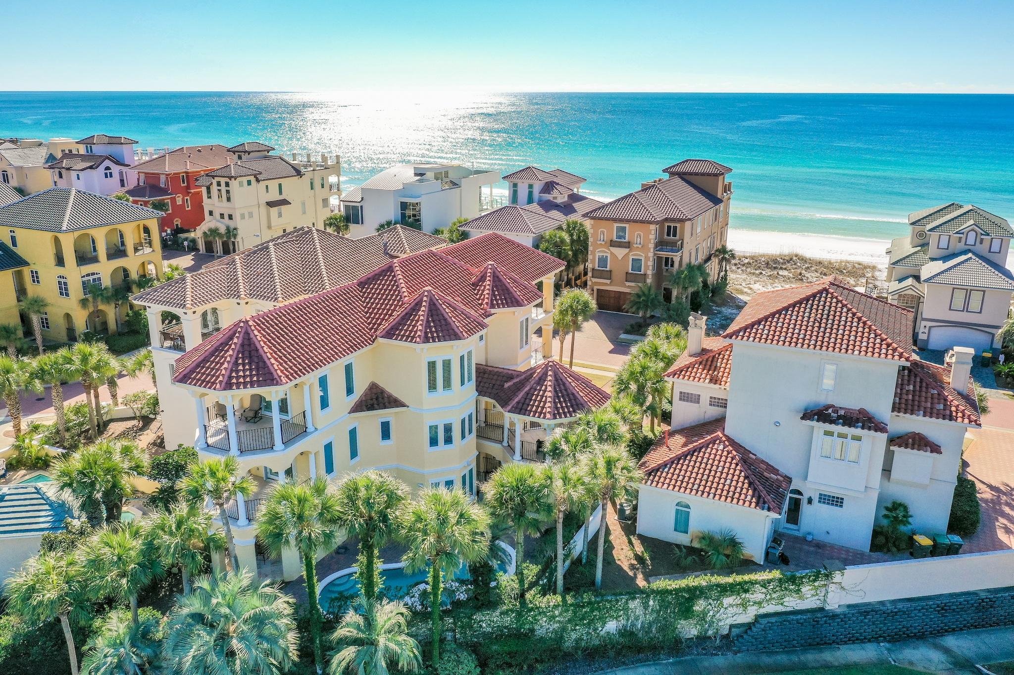1st Tier Mediterranean villa with sweeping Gulf and lake views and a rare, full-size heated pool and spa in exclusive, guard-gated Destiny by the Sea. Recently updated by Ono Horn Design in today's neutrals and located on one of DBTS's largest lots. The home''s strategic octagonal design receives a remarkable amount of natural light, offers incomparable 360-degree views, and maximizes energy efficiency. Never rented and immaculate, vacation rental projections top $159K annually. This home commands fresh air space with a record 7 balconies. The kitchen features the axioms of a gourmet kitchen - granite counters, stainless appliances, plenty of workspace, and seating. Plus, its octagonal shape and see-through glass cabinets ensure unobstructed views. An elevator services all three floors.